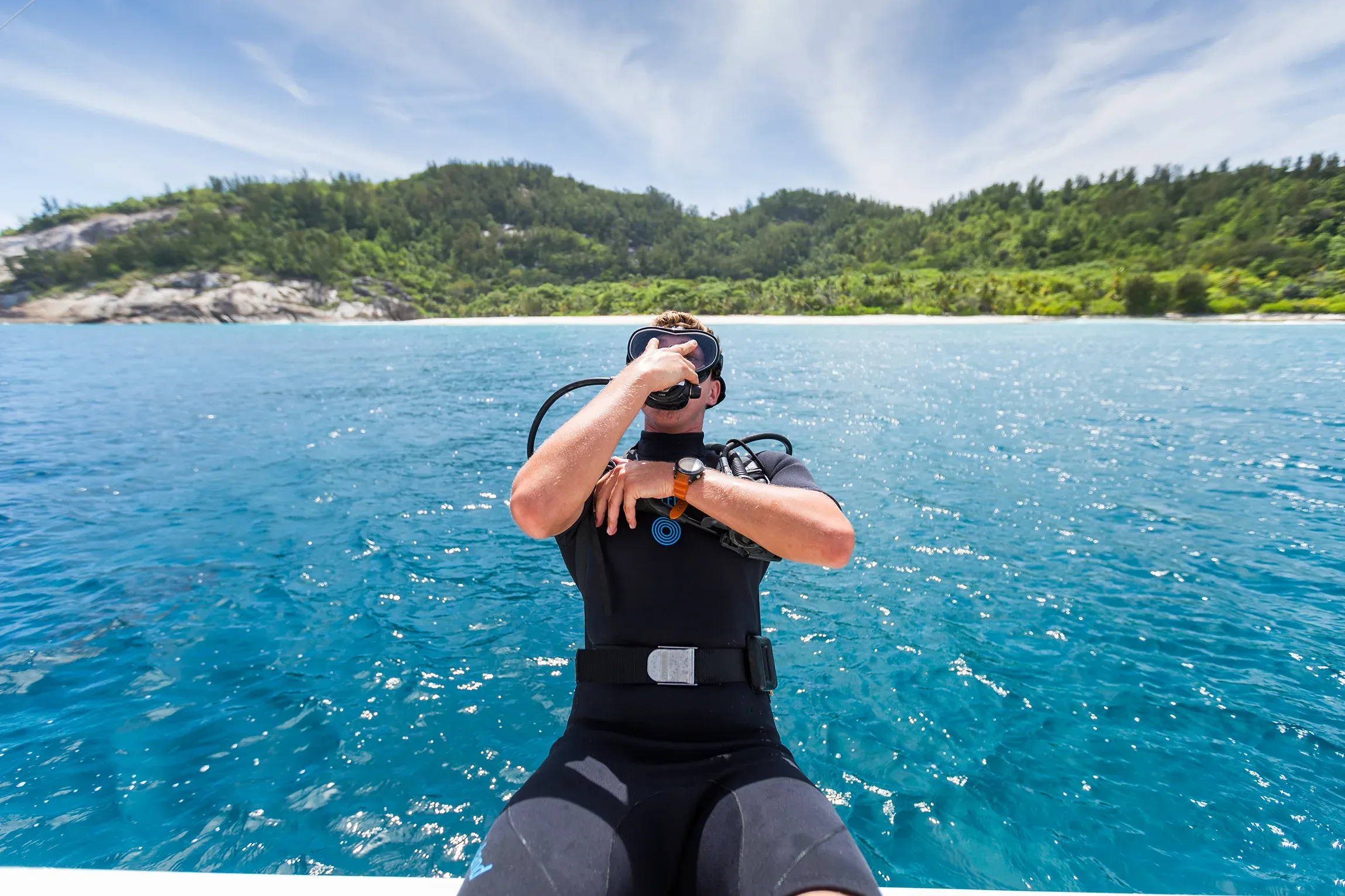 Diver descending over a coral reef near North Island, Seychelles