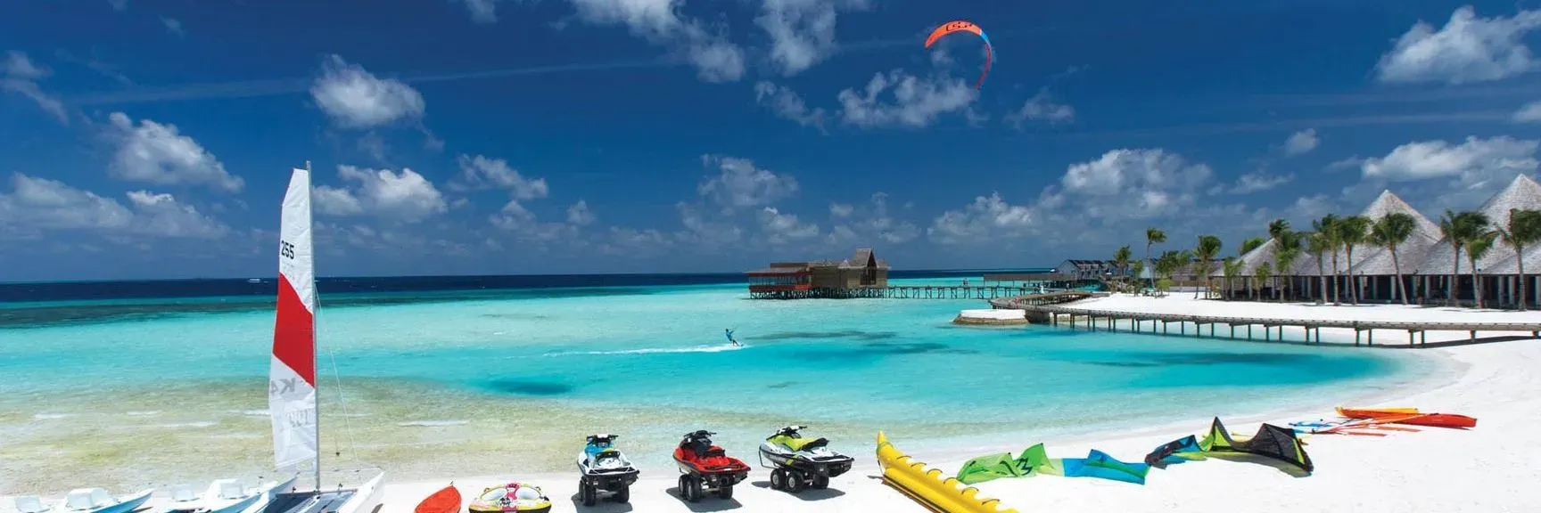 Watersports equipment and kitesurfer on the lagoon at OZEN LIFE MAADHOO
