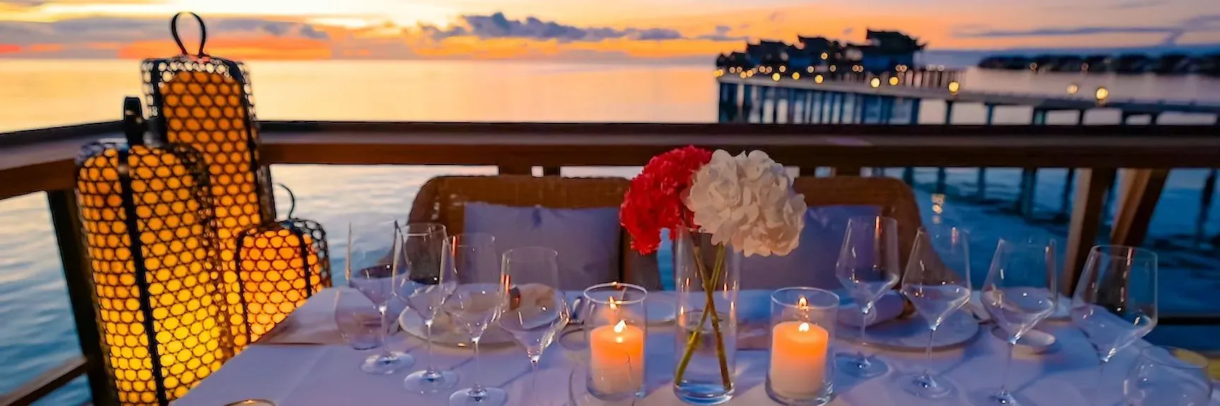 Sunset dining table set for two overlooking the lagoon at OZEN RESERVE BOLIFUSHI