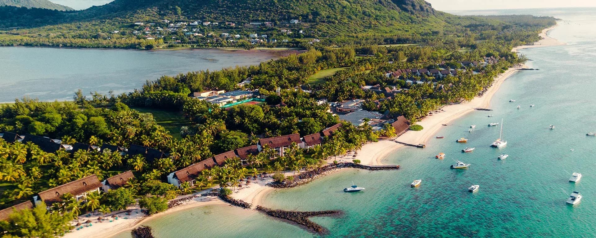 Aerial view of Paradis Beachcomber Golf Resort & Spa on the Le Morne peninsula, with Le Morne Brabant mountain, tropical gardens and the lagoon, Mauritius