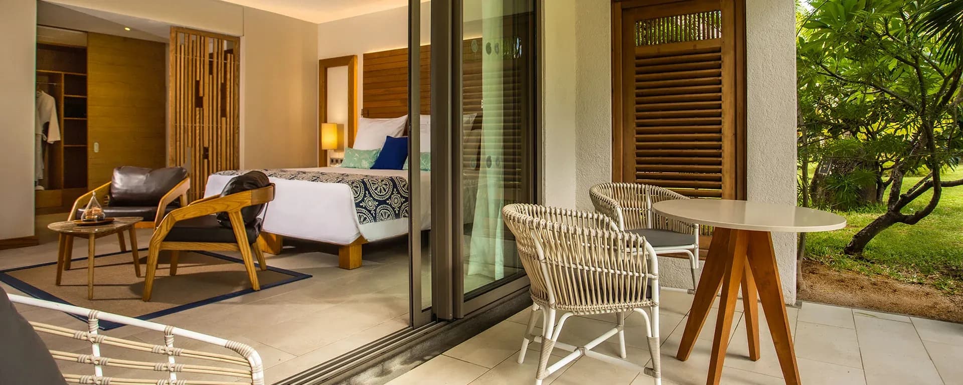 Paradis Bay View room interior in warm wood tones at Paradis Beachcomber