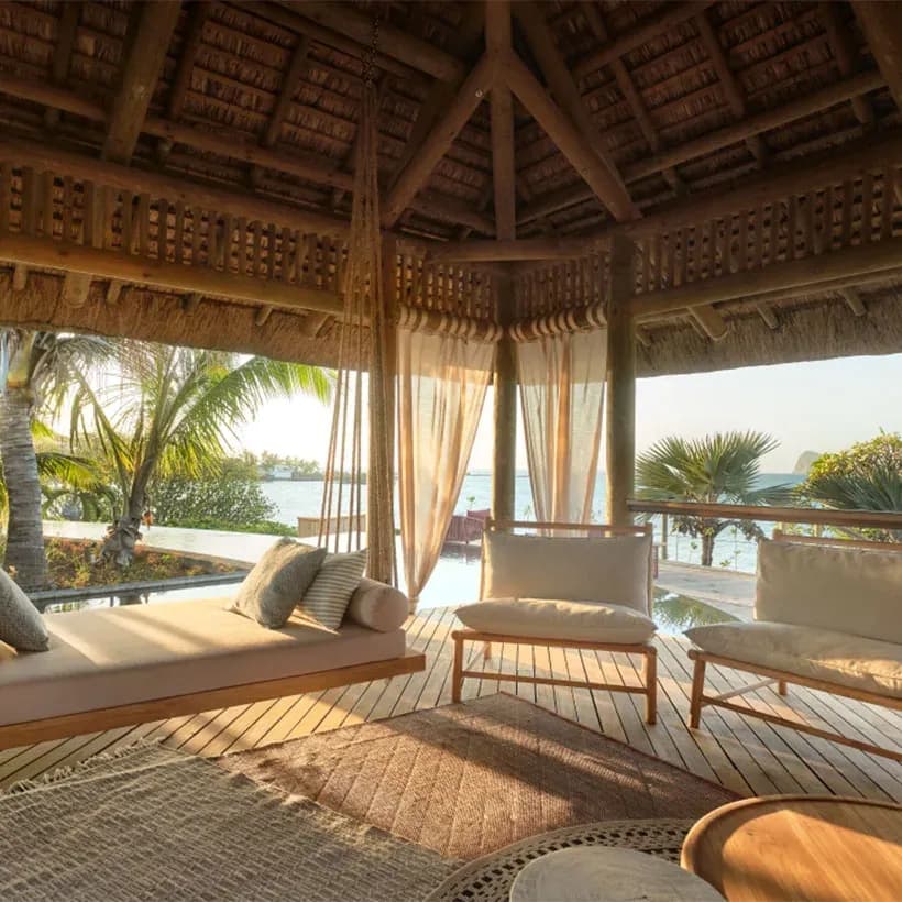 Secluded thatched Love Nest daybed pavilion overlooking the sea at Paradise Cove Boutique Hotel