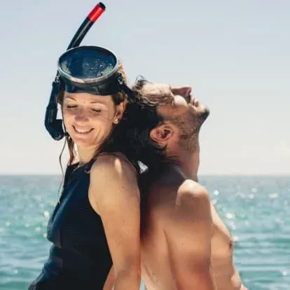 Guests snorkelling off the beach at Paradise Cove Boutique Hotel