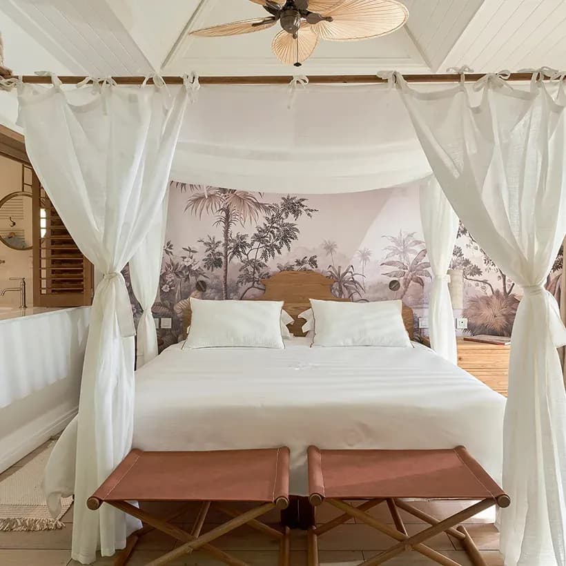 Deluxe Premium Room interior with four-poster bed at Paradise Cove Boutique Hotel