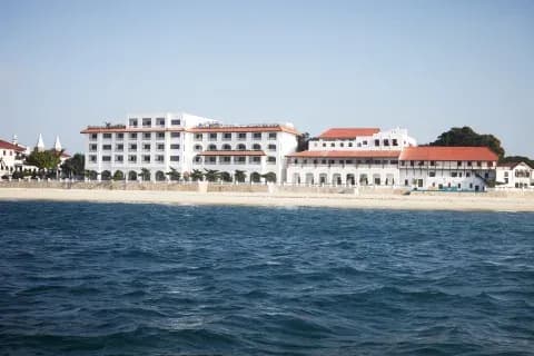 Aerial view of Park Hyatt Zanzibar's beachfront wings along Stone Town's waterfront
