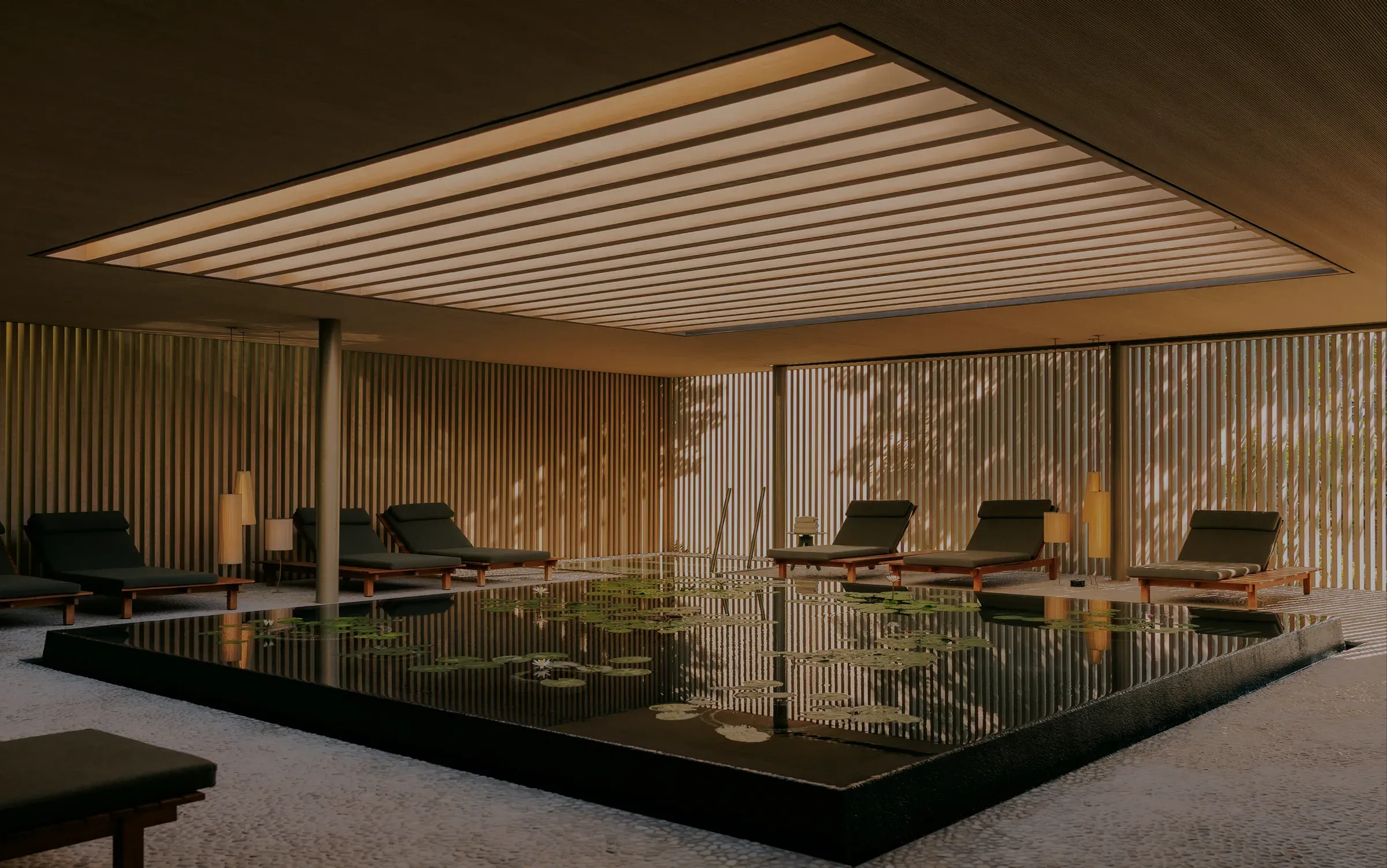 Relaxation lounge with reflecting lily pond at Flow Spa, Patina Maldives