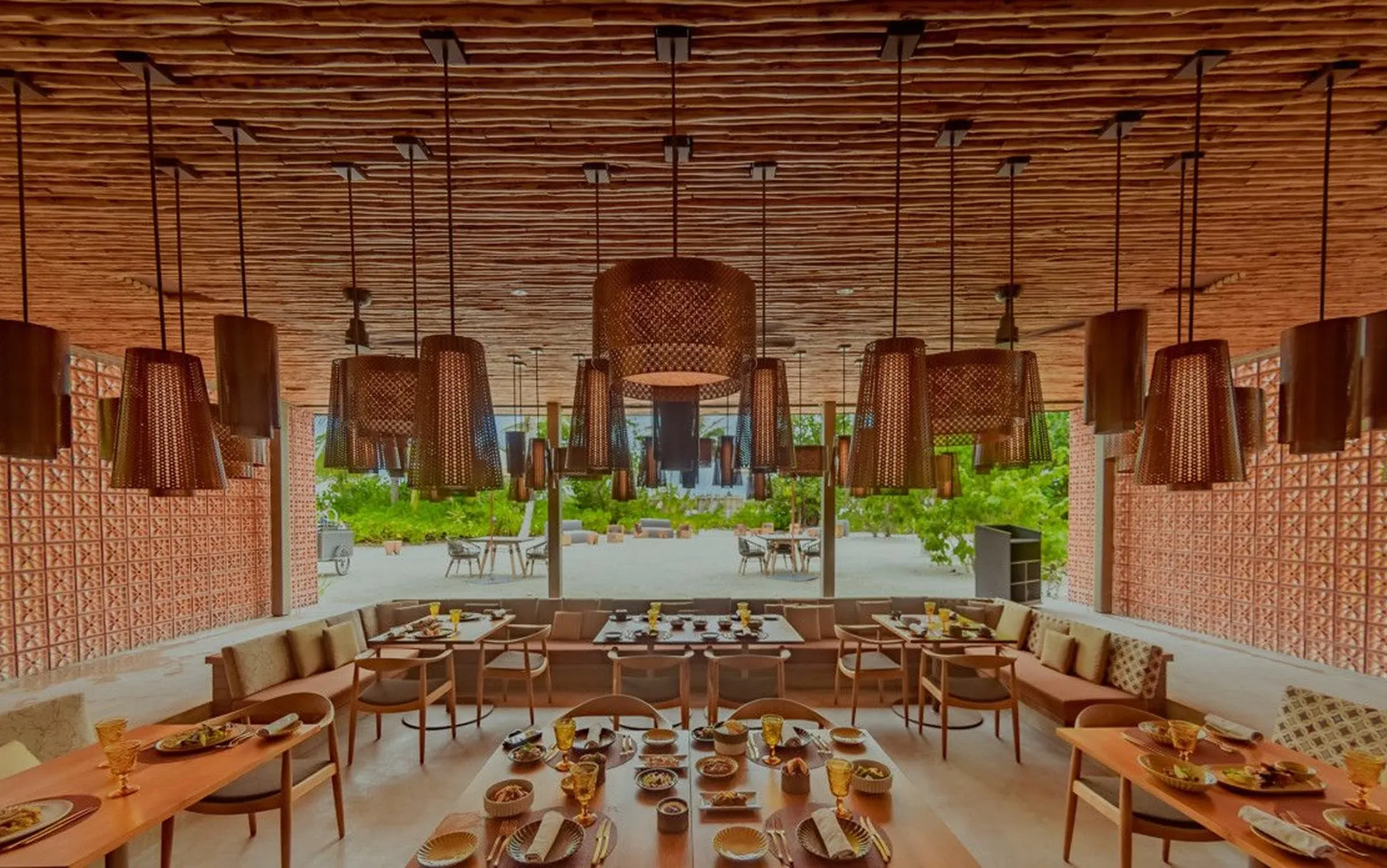 Elegant dining room with gold-toned tableware at Arabesque, Patina Maldives