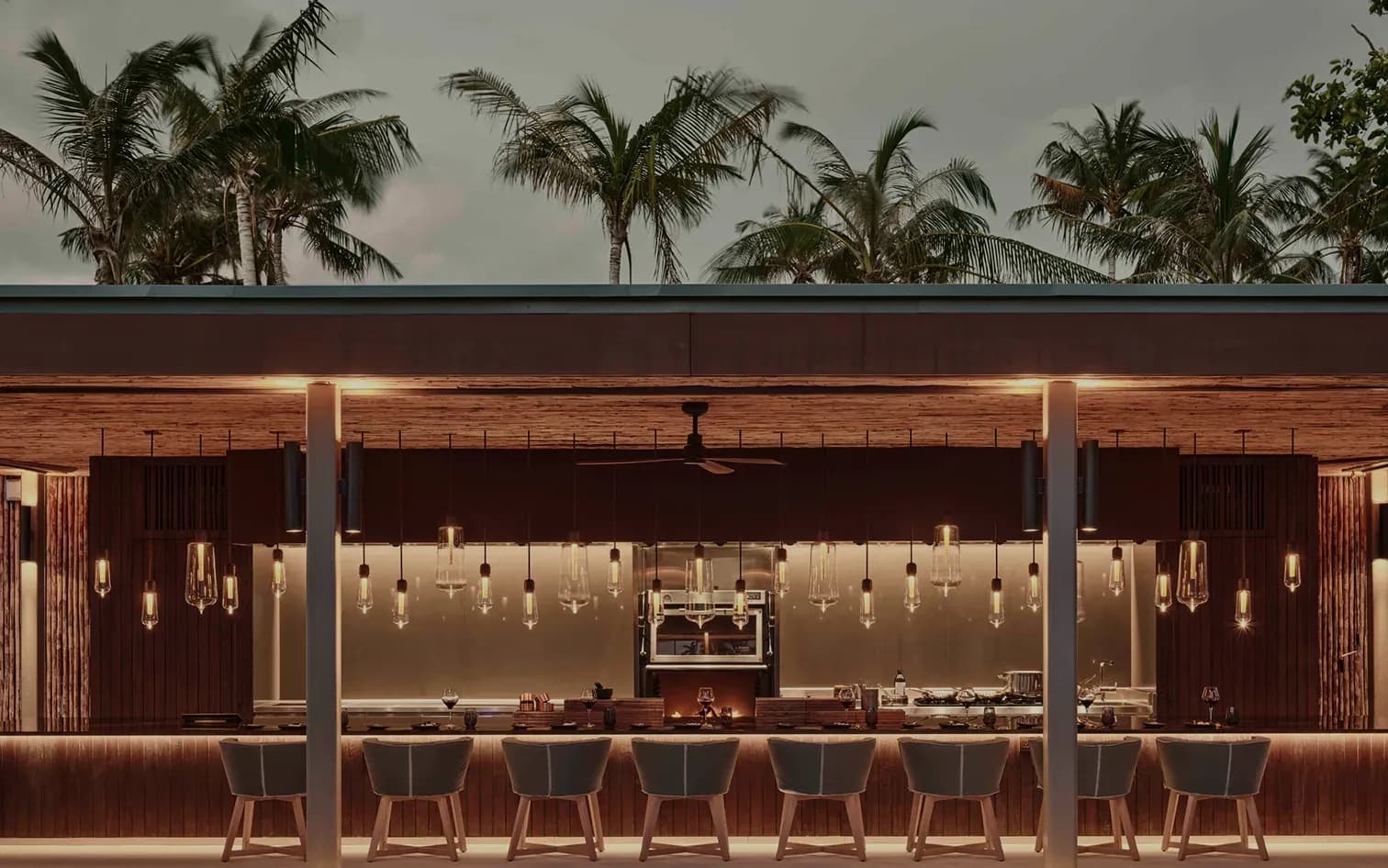 Outdoor bar and open-grill setting at Brasa steakhouse, Patina Maldives