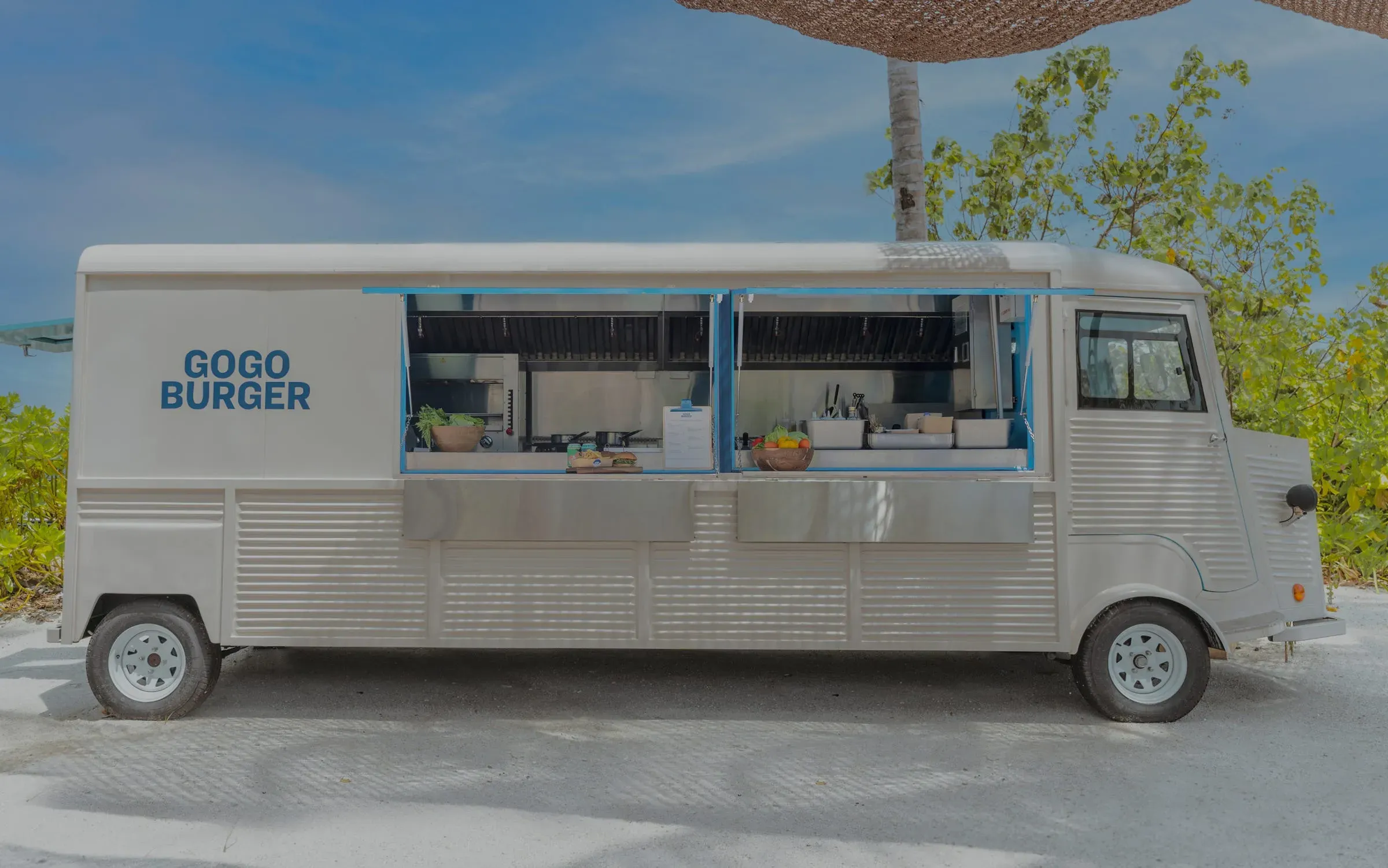 Retro burger food truck in a tropical setting at Fari Marina Village Dining Depot, Patina Maldives