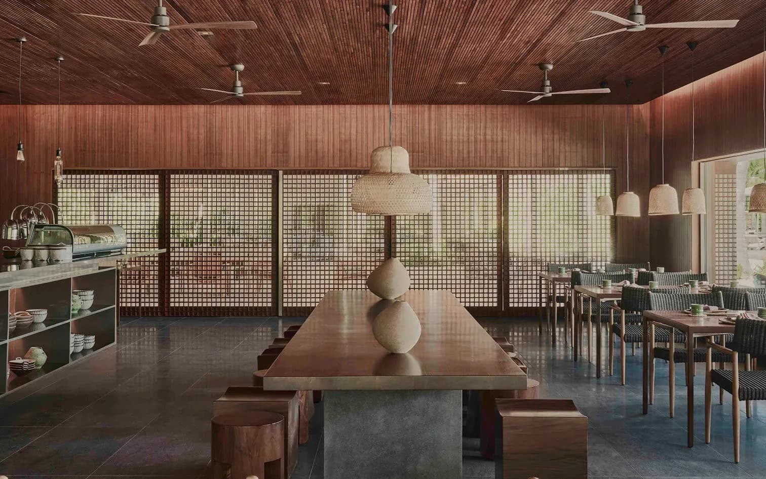 Communal dining table under pendant lights at Wok Society, Patina Maldives