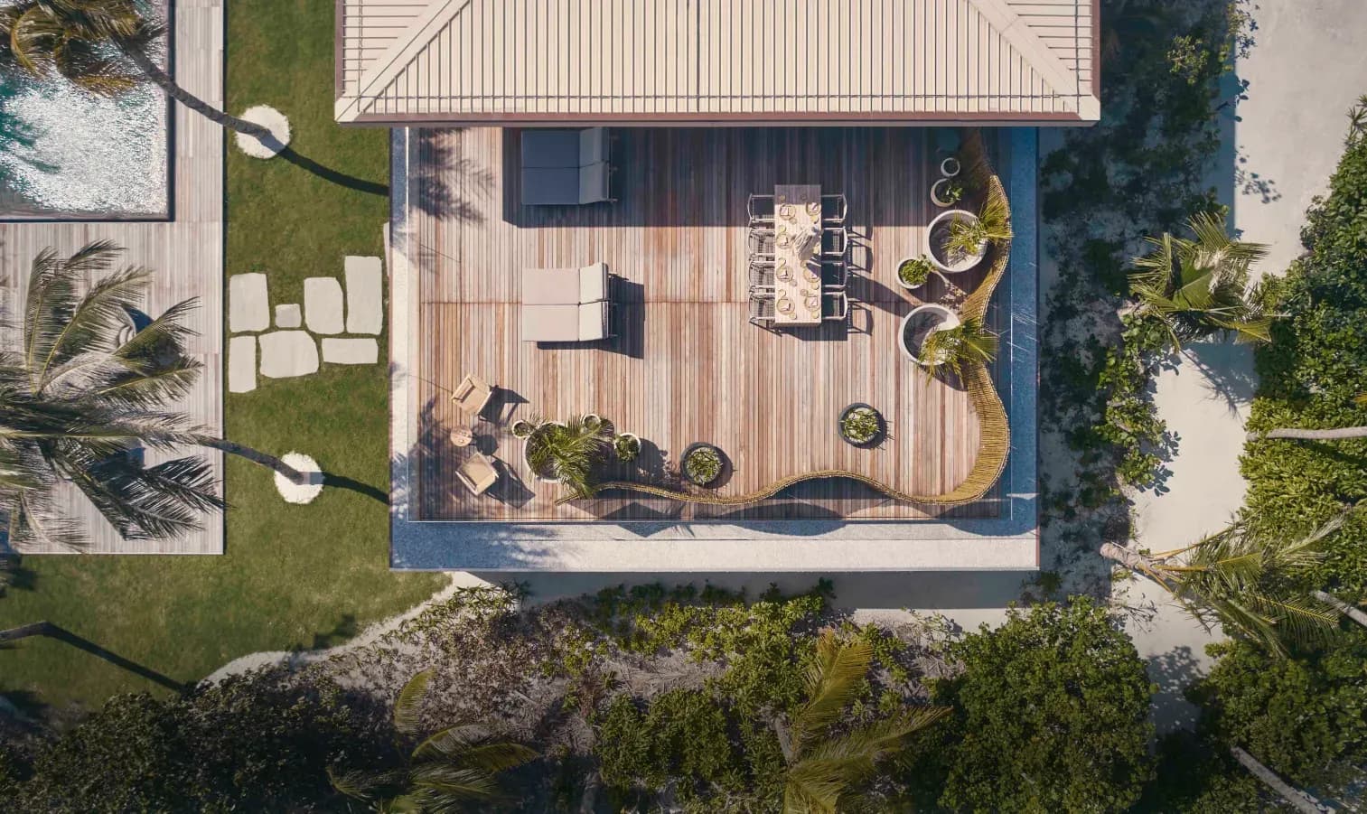 Aerial view of The Beach House's upper deck, dining table and private pool, Patina Maldives