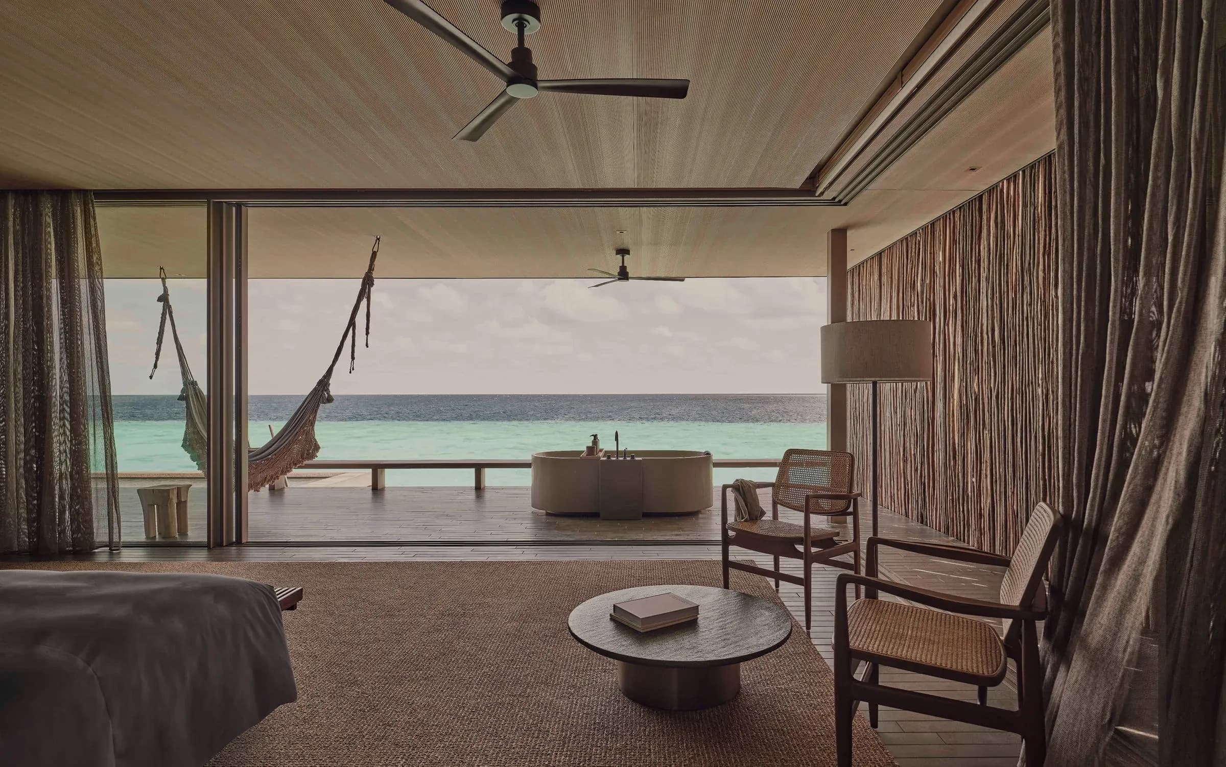 Oceanfront deck with hammock at a Two Bedroom Sunset Water Pool Villa, Patina Maldives