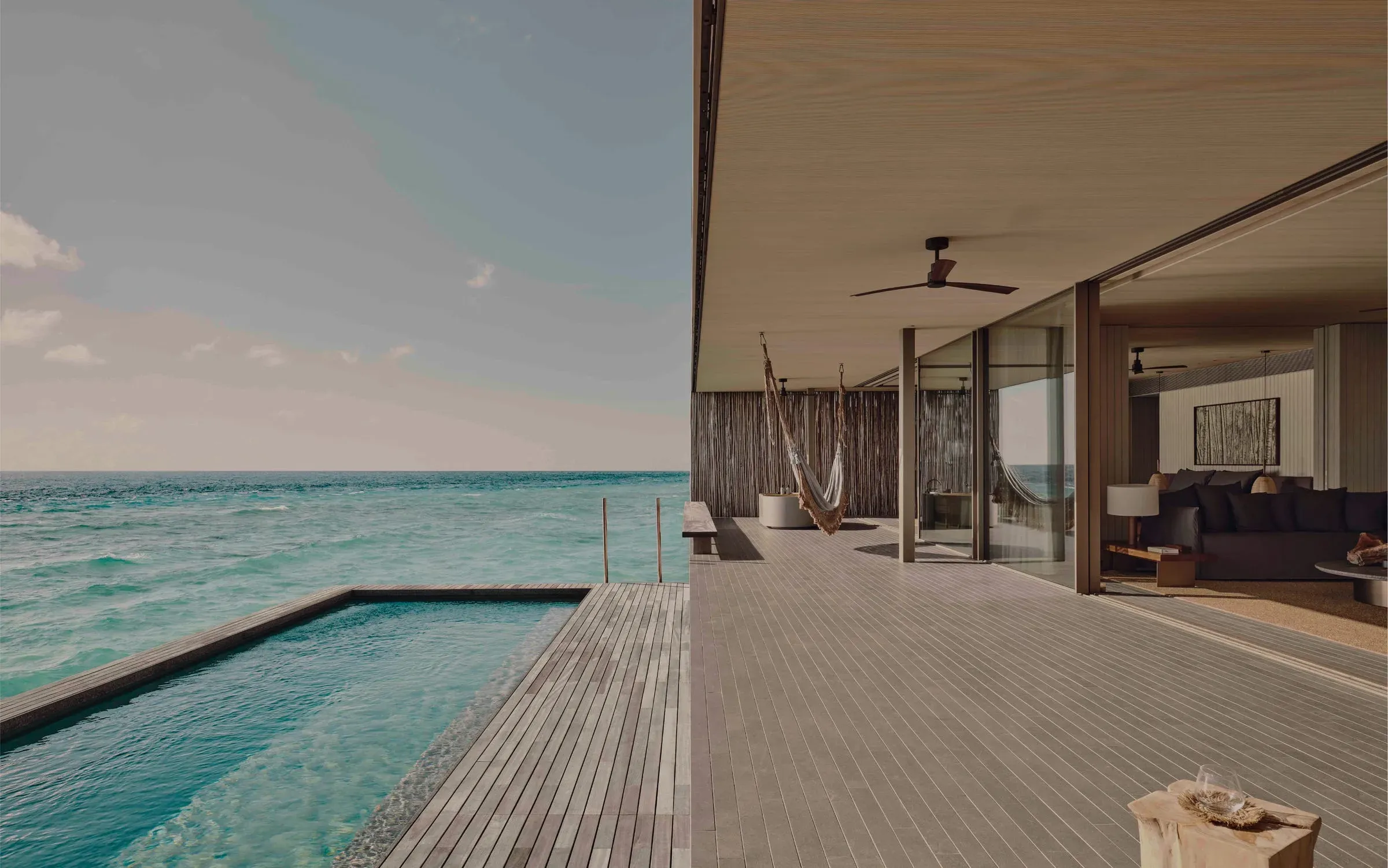 Deck and private pool overlooking turquoise ocean at a Two Bedroom Water Pool Villa, Patina Maldives