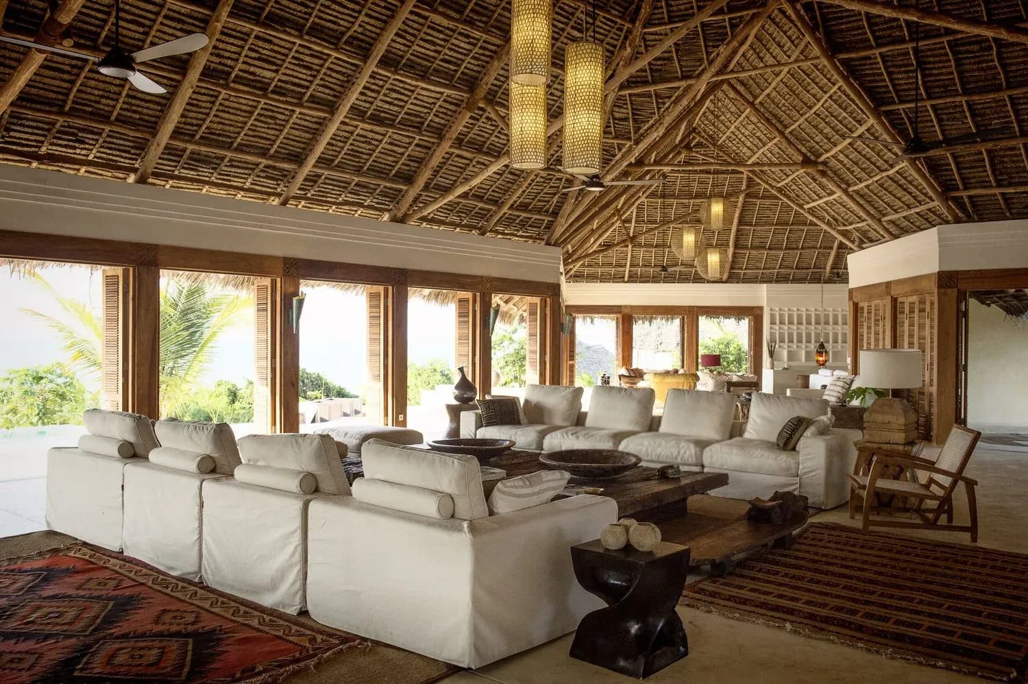 The Great Room at Qambani Luxury Resort, a vaulted thatched living pavilion open to the garden
