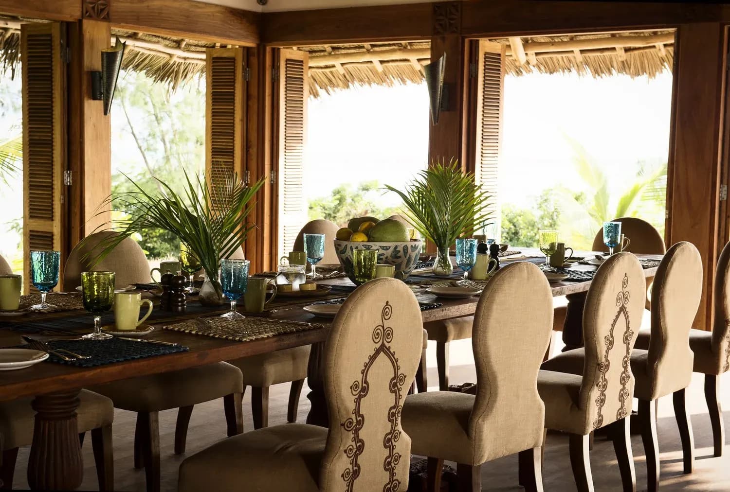 Dining table set for a meal in the open-air dining room at Qambani Luxury Resort