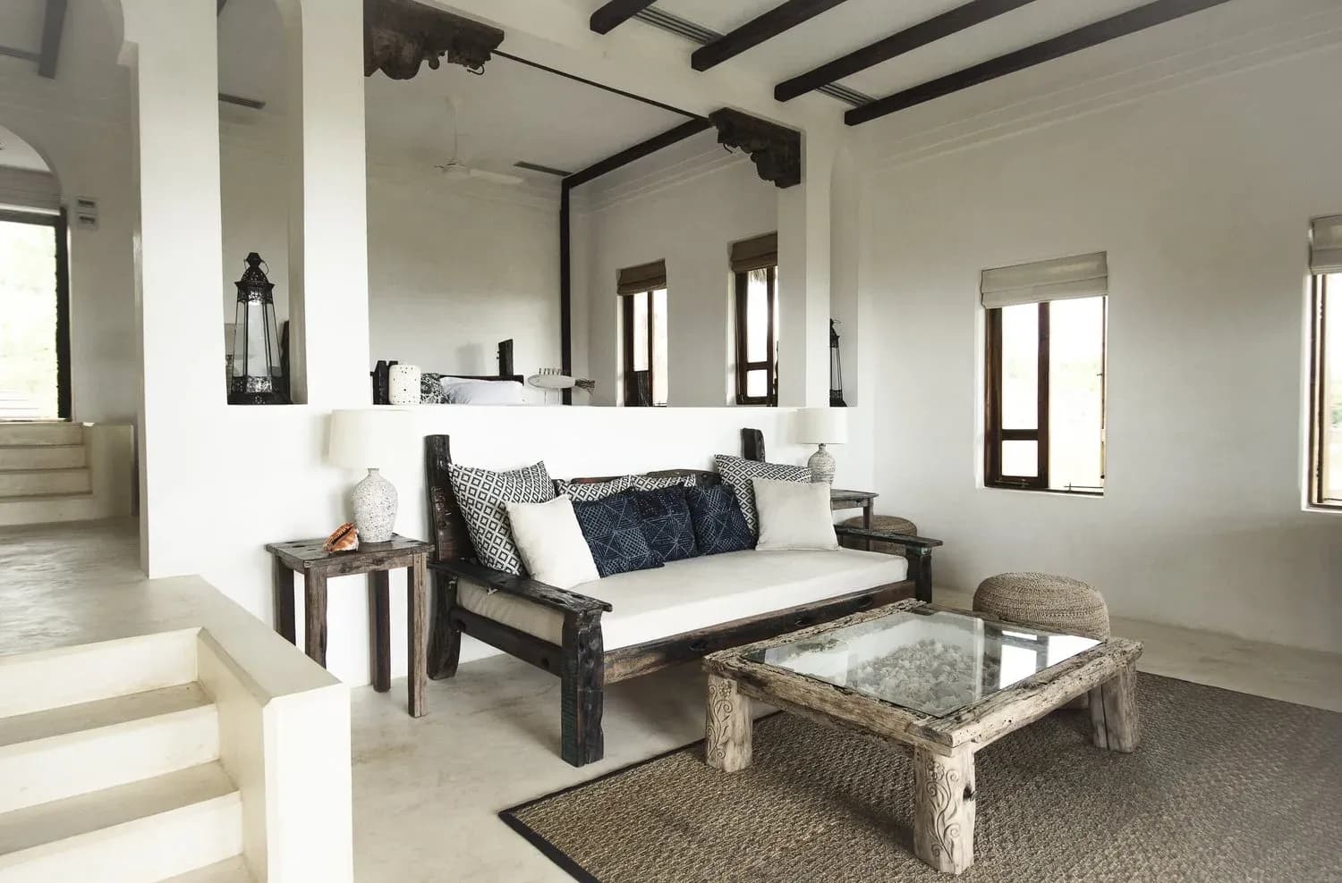 Castaway Villa living area at Qambani Luxury Resort with nautical blue tones and antique boat timber furniture