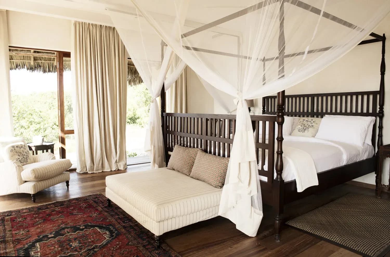Plantation Villa four-poster bed at Qambani Luxury Resort with colonial-style furnishings