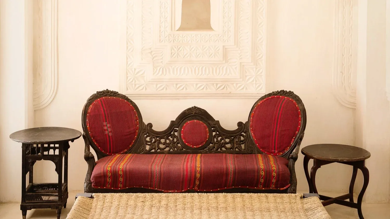 Sundowner Villa bedroom at Qambani Luxury Resort with teal chairs and garden views