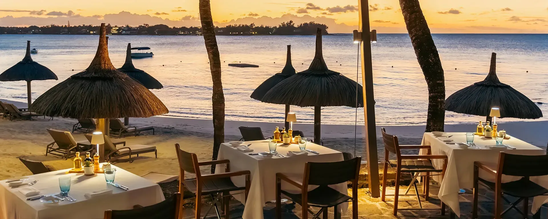 Grand Sable beachfront restaurant under a badamier tree at Royal Palm Beachcomber Luxury