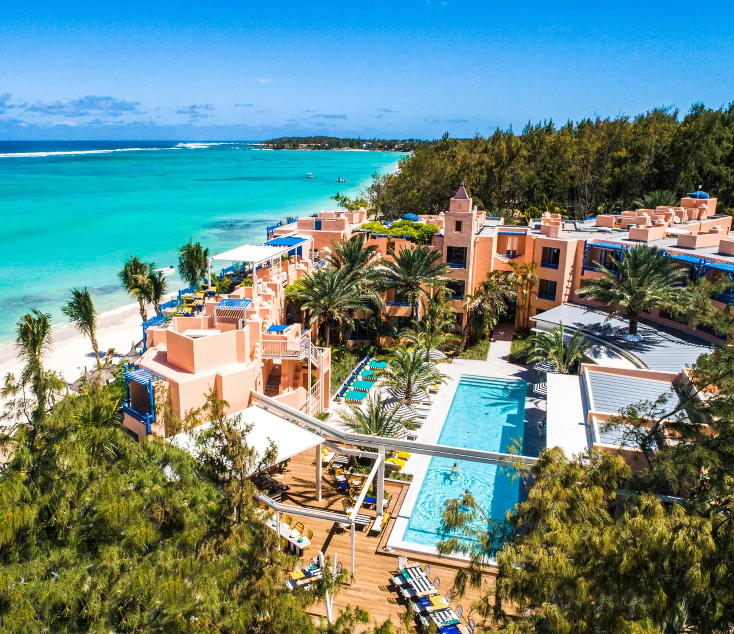Aerial view of SALT of Palmar's terracotta-pink pavilions, pools and beach on Mauritius' east coast