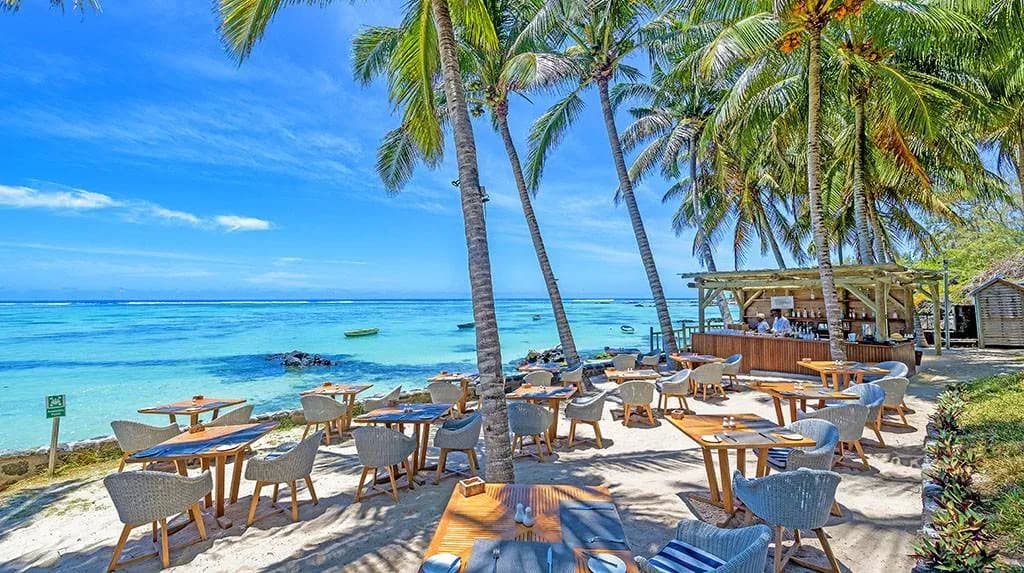 Ti Lambic beach bar under palm trees at Seasense Boutique Hotel & Spa