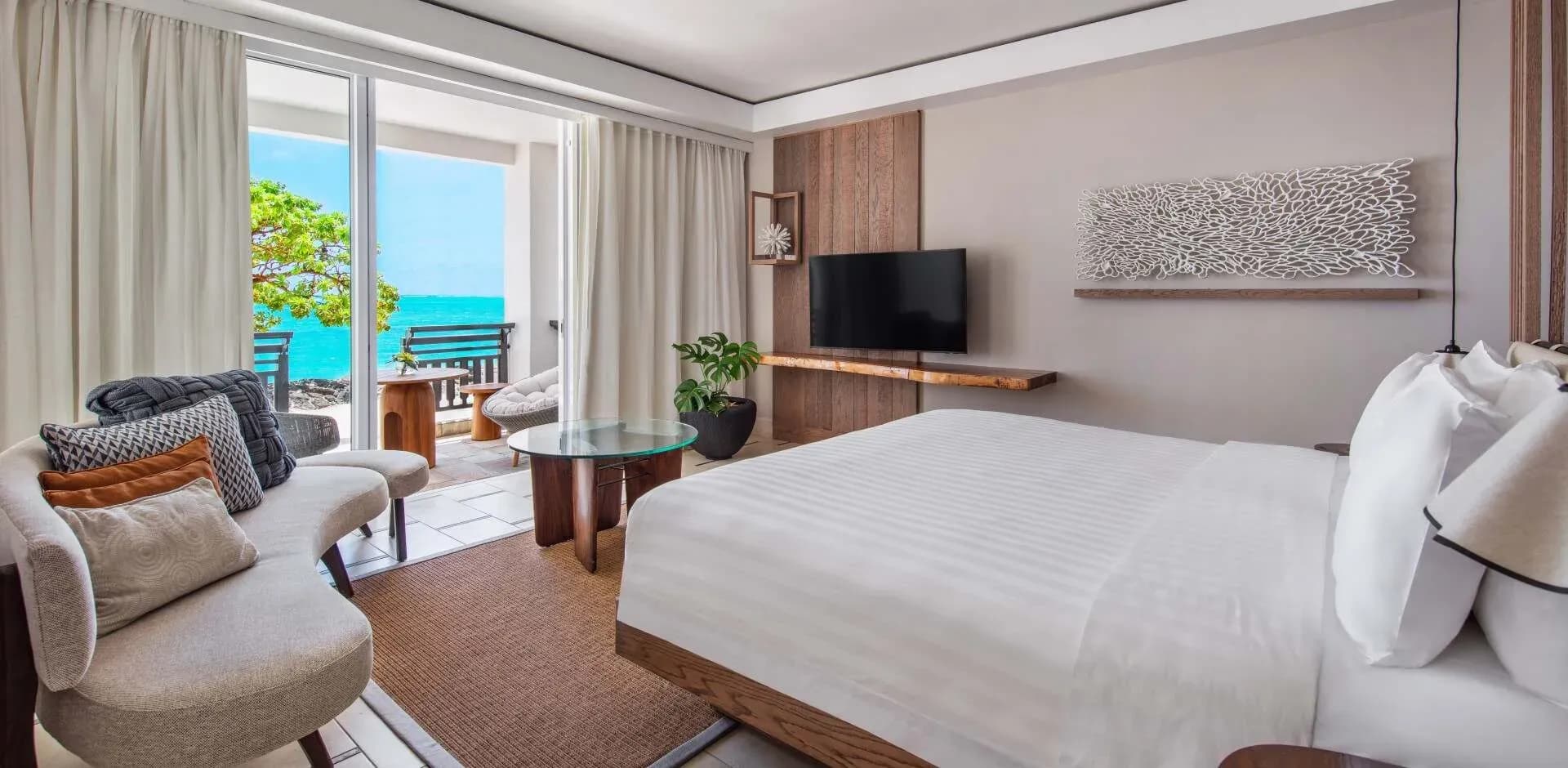 Frangipani Beachfront Junior Suite bedroom with beach access at Shangri-La Le Touessrok