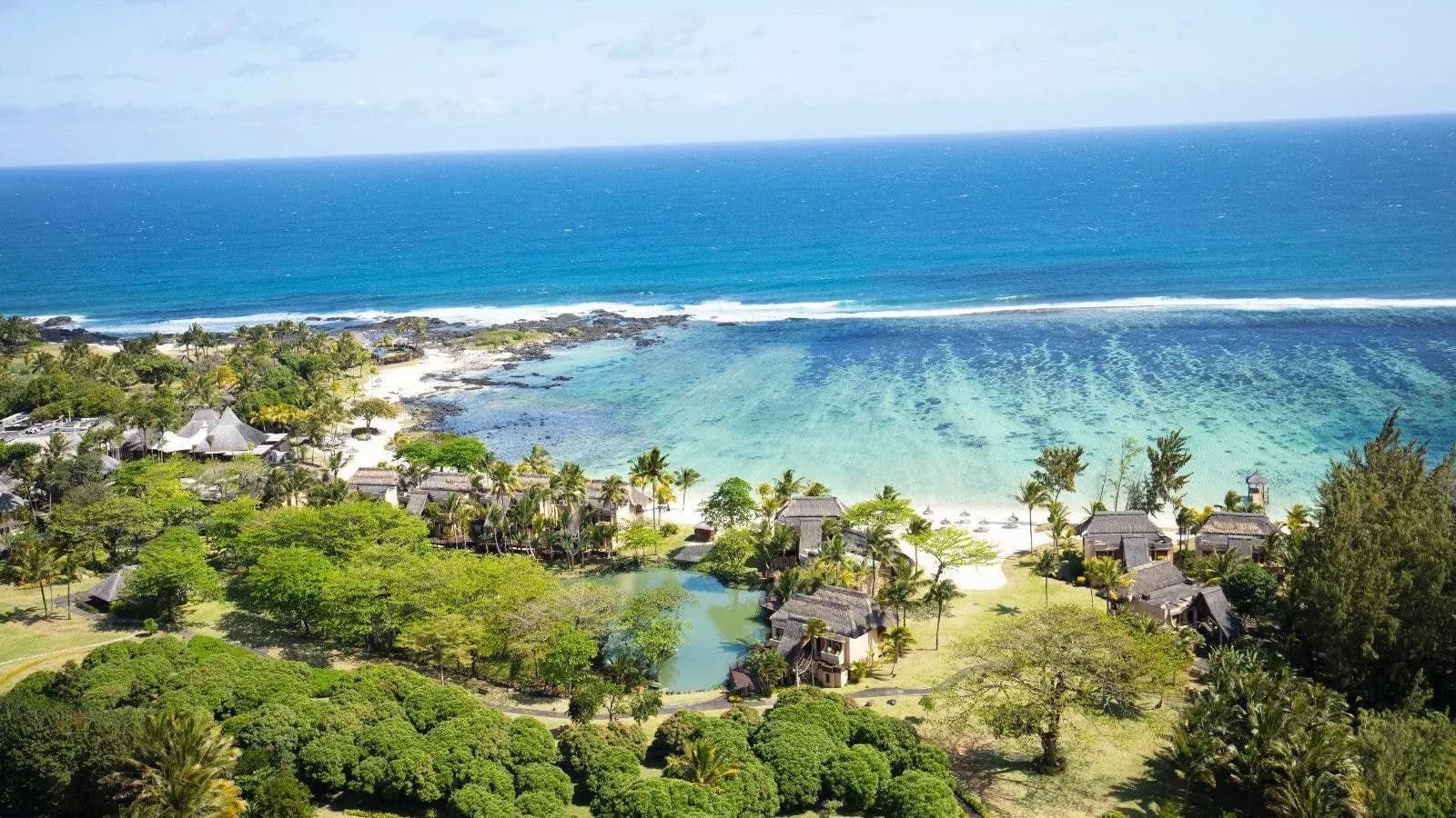 Aerial view of Shanti Maurice Resort & Spa's beachfront and sheltered bay on Mauritius' south coast