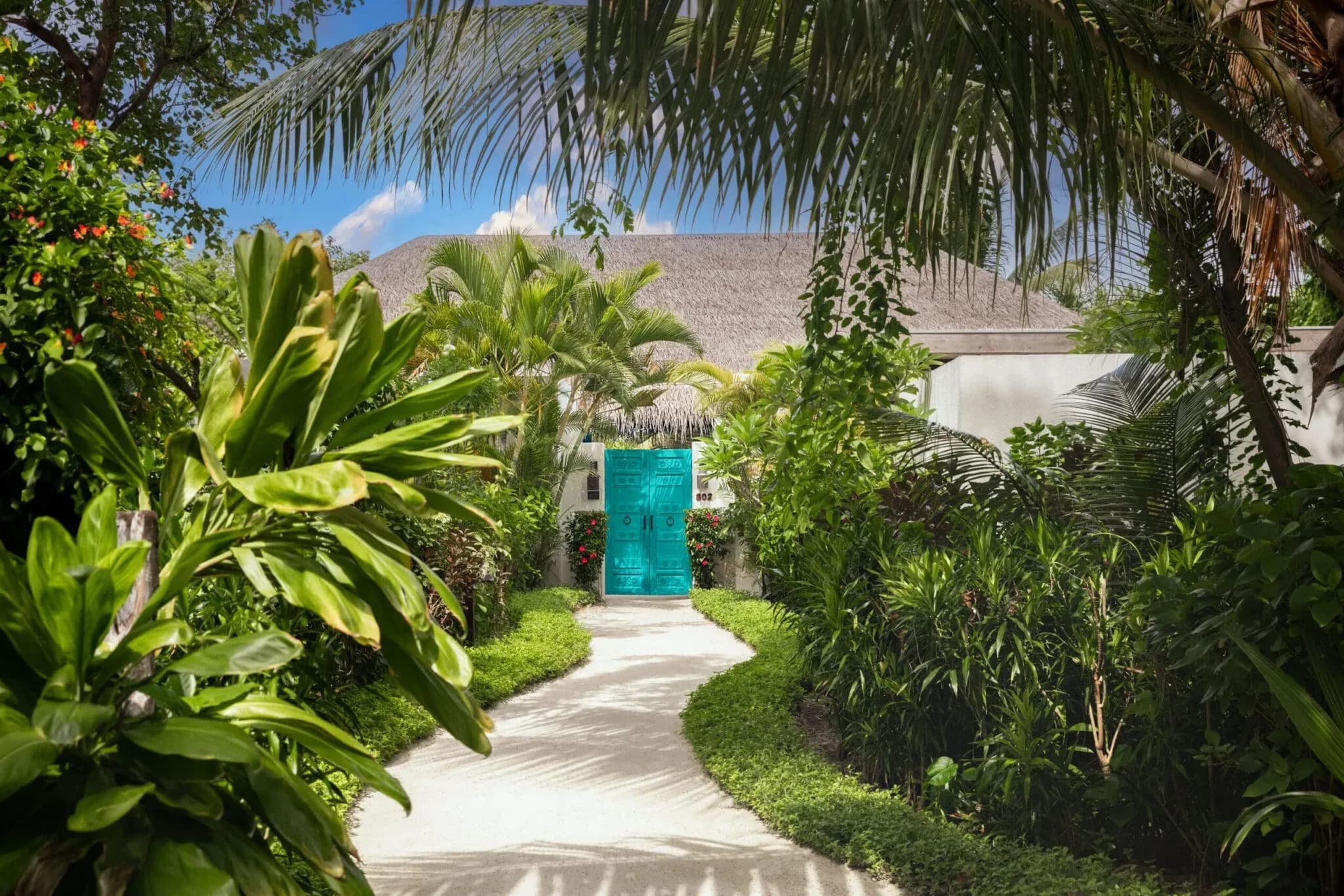 Garden pathway to a beach villa entrance at Sirru Fen Fushi