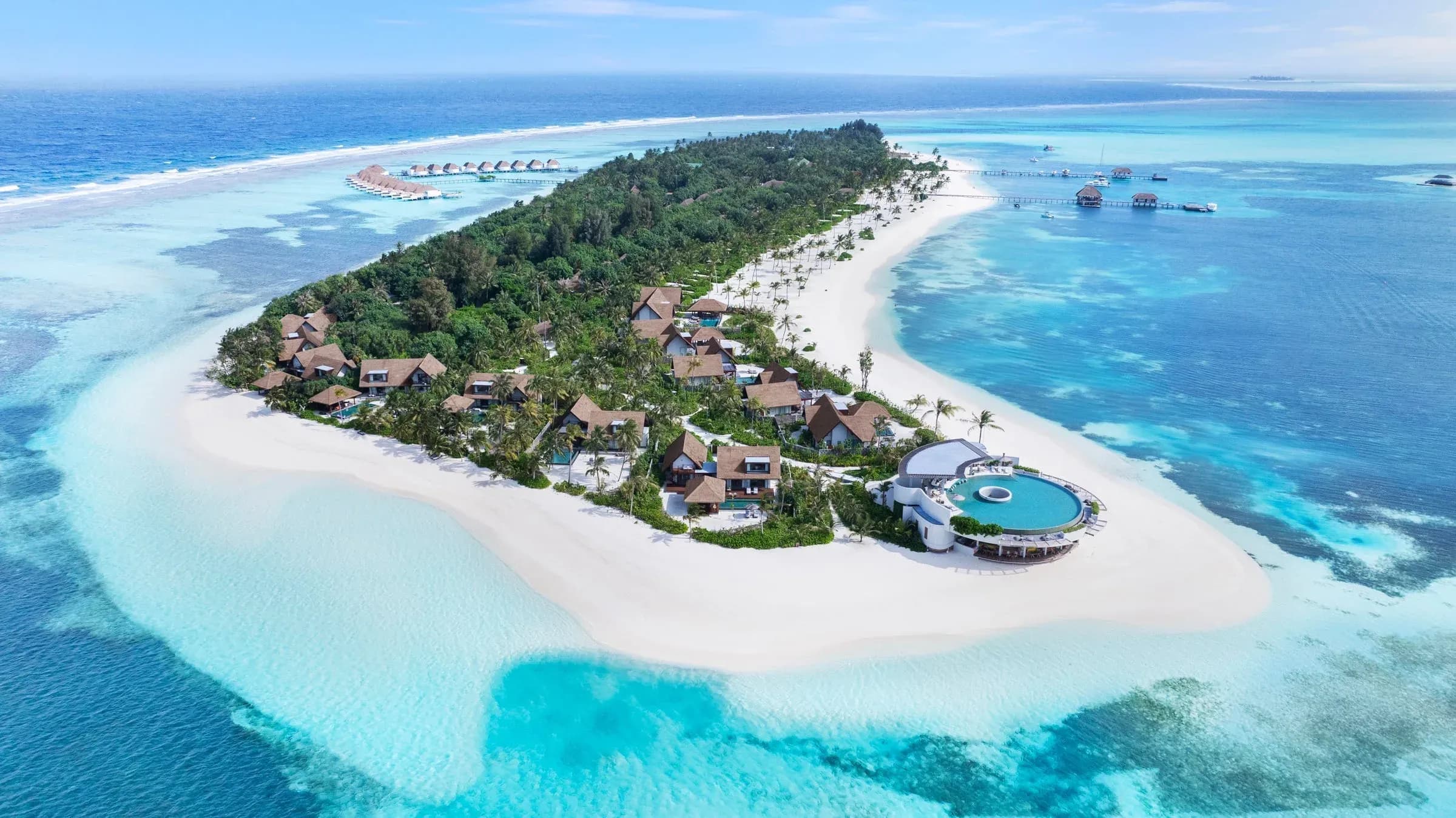 Aerial view of Six Senses Kanuhura's overwater pool villas over the turquoise lagoon, Lhaviyani Atoll, Maldives