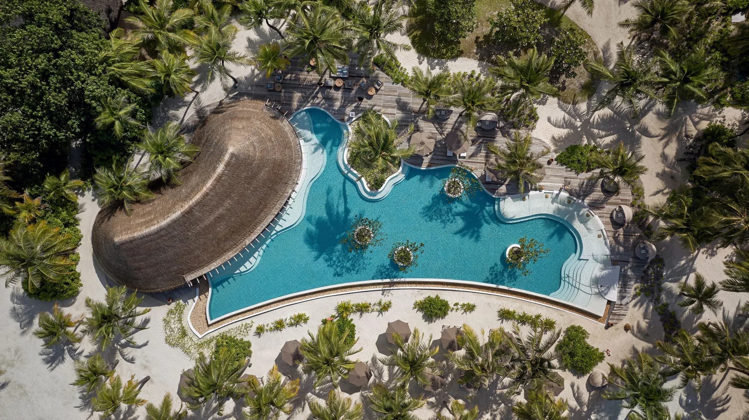 Aerial view of the pool and dining deck at Sip & Sand, Six Senses Kanuhura