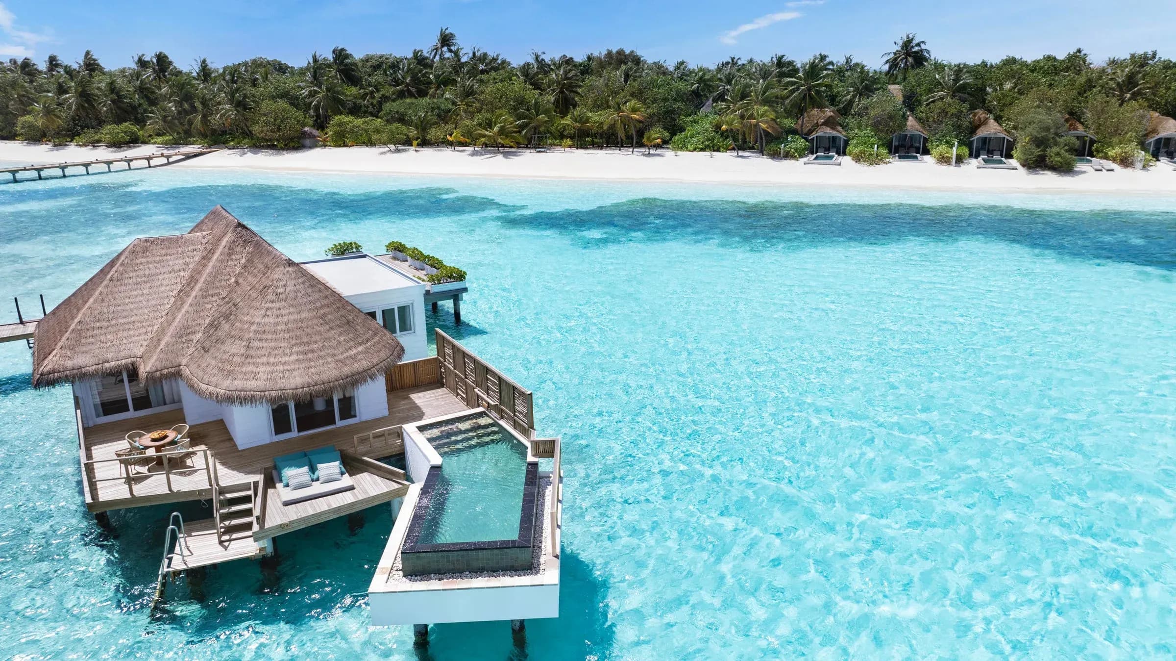 A Family Water Villa With Pool over the turquoise lagoon at Six Senses Kanuhura