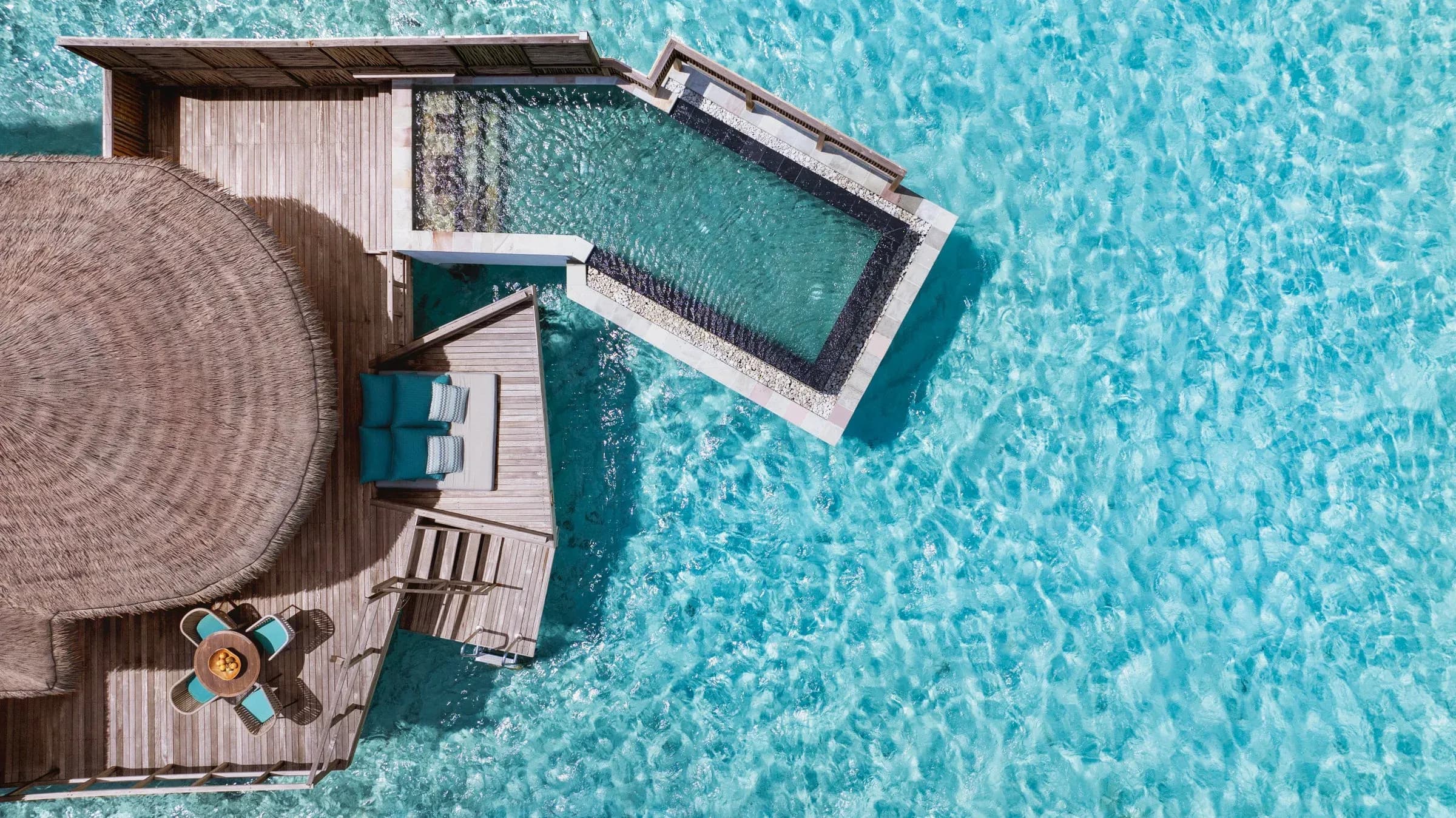 A Water Villa With Pool perched over the lagoon at Six Senses Kanuhura