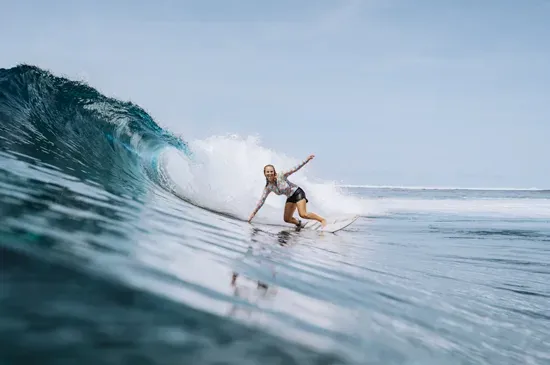 Surfer riding a wave at the Yin Yang break near Six Senses Laamu