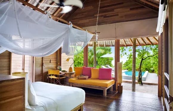 Interior of the Lagoon Water Villa at Six Senses Laamu, facing the turquoise lagoon