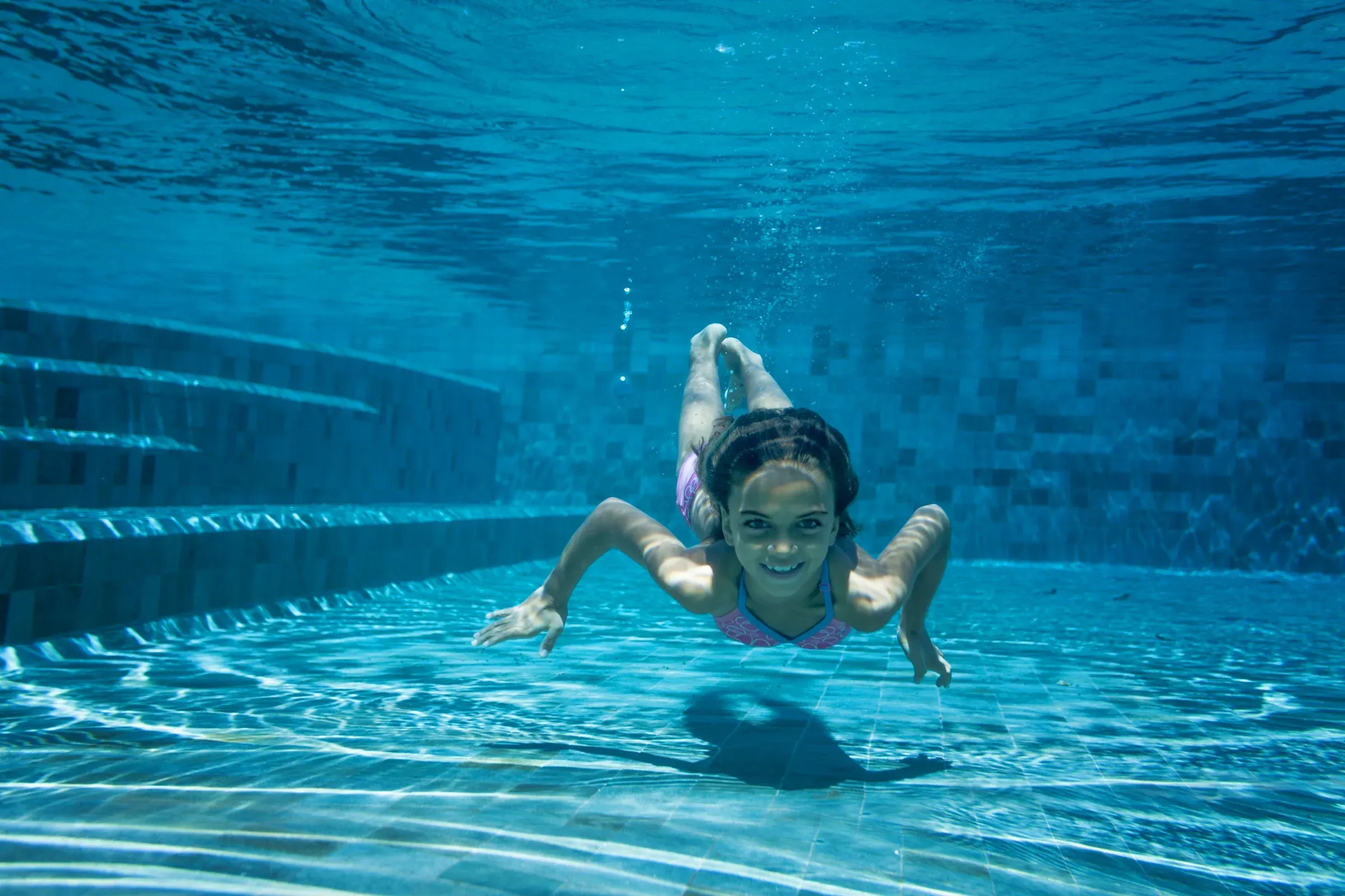 Children playing at the main swimming pool at Six Senses Zil Pasyon