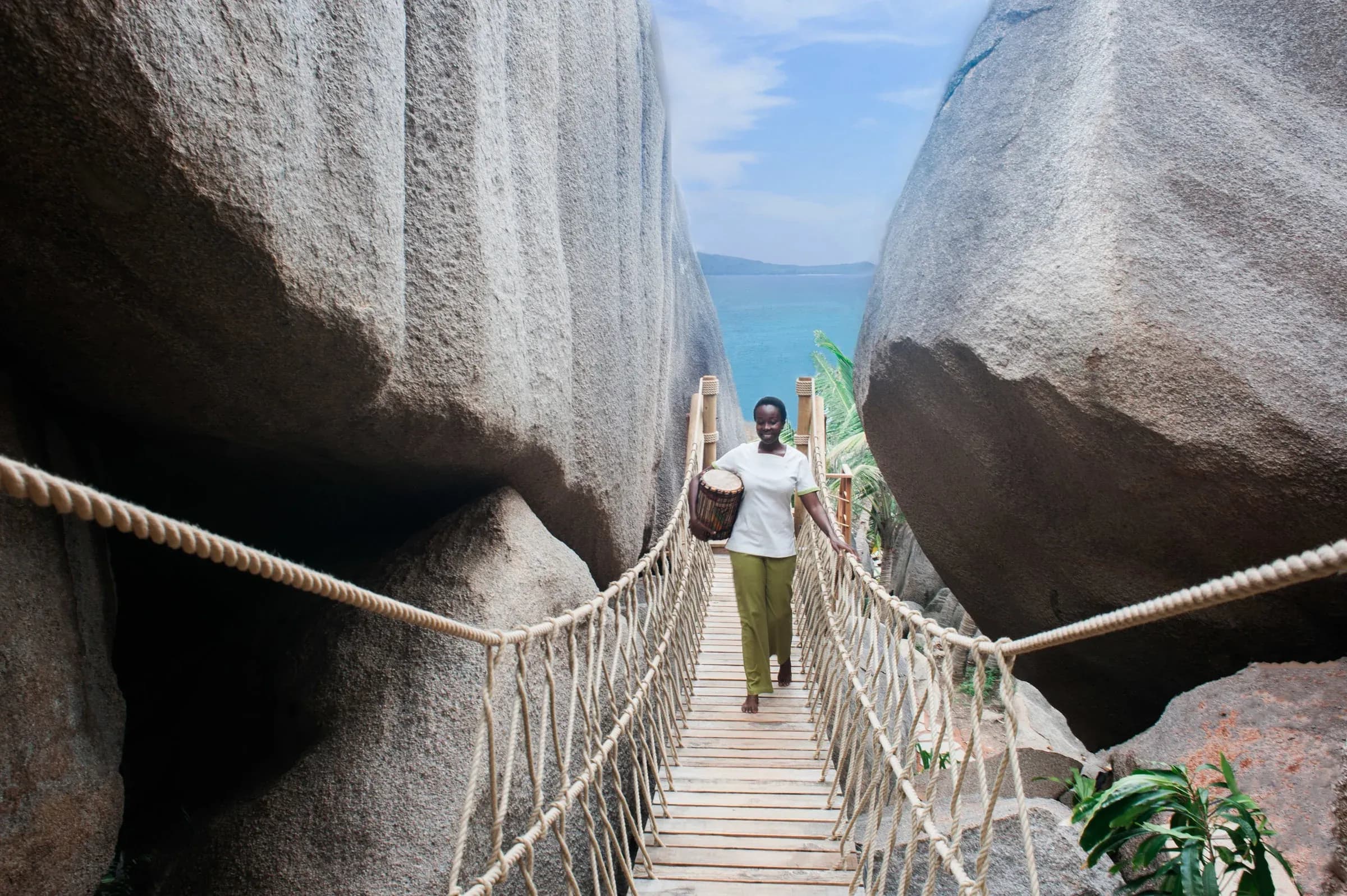 Rope bridge leading to the Six Senses Spa treatment villas among the granite boulders