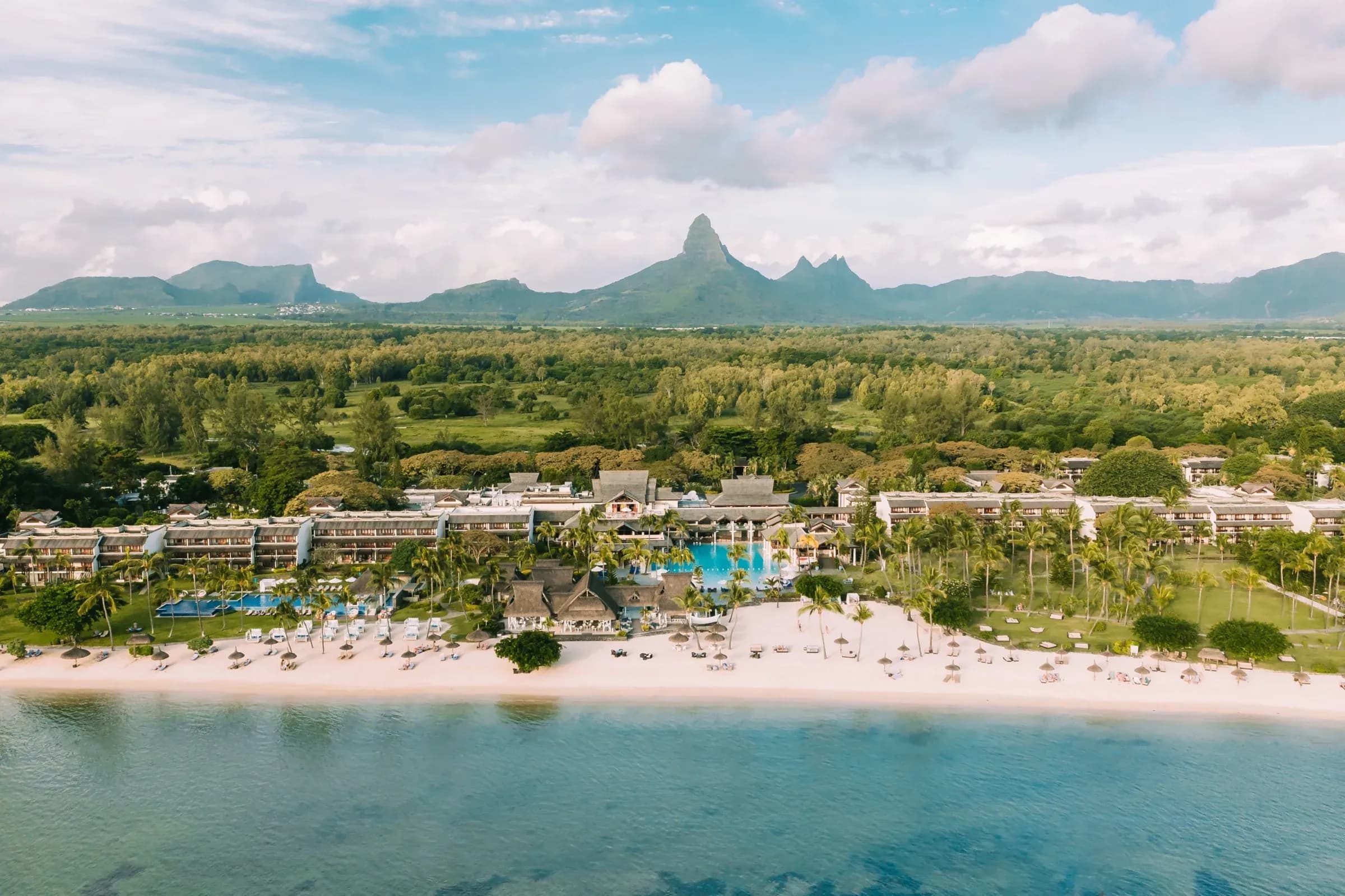 Aerial view of Sofitel Mauritius L'Impérial Resort & Spa beachfront with mountain backdrop, Wolmar, Flic en Flac
