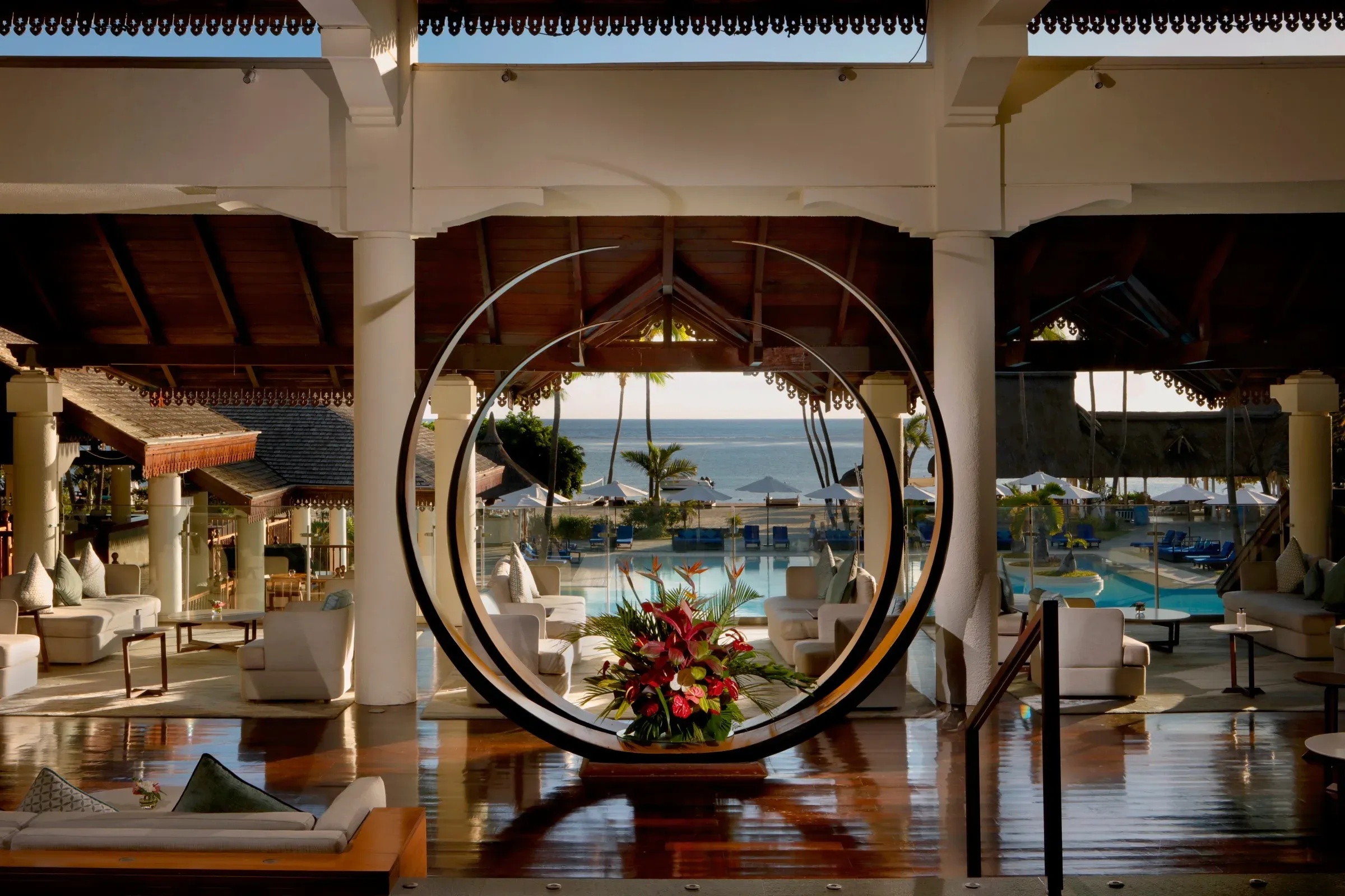 Lobby archway framing the pool and Indian Ocean at Sofitel Mauritius L'Impérial Resort & Spa