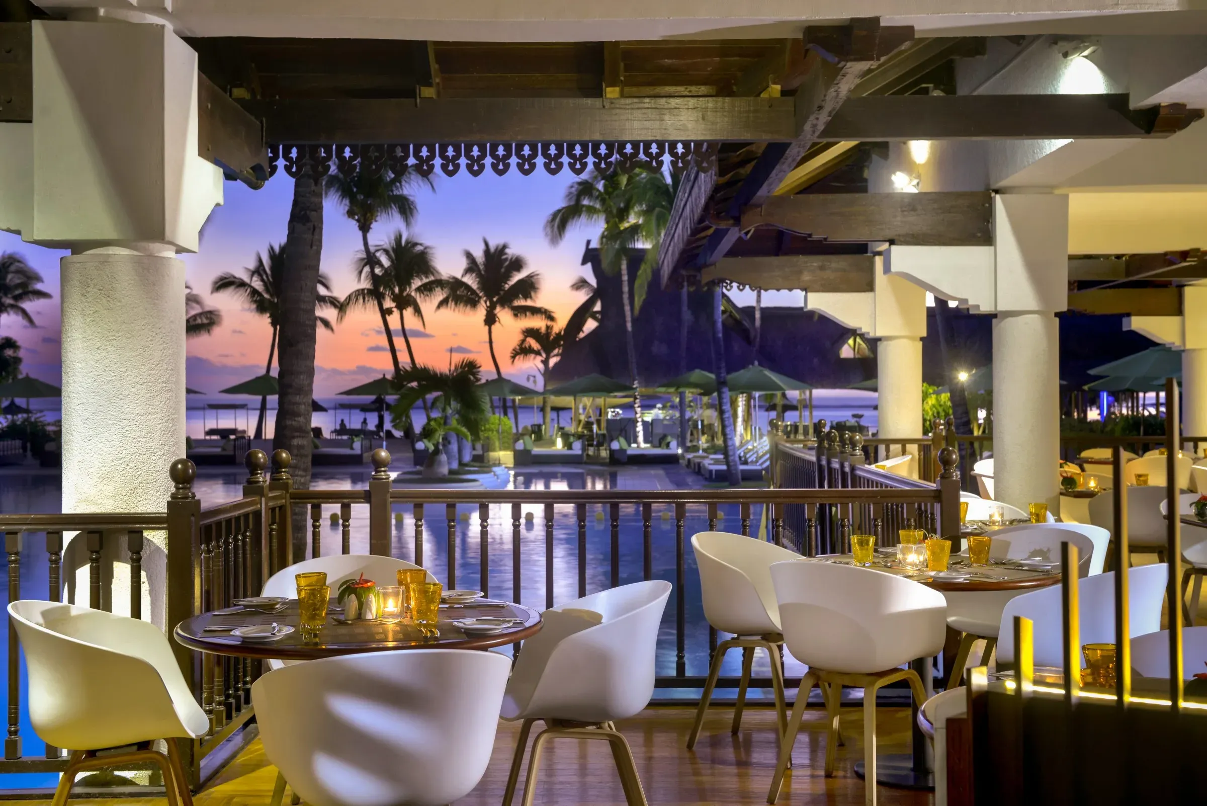 Ravinala restaurant terrace at sunset overlooking the pool at Sofitel Mauritius L'Impérial Resort & Spa