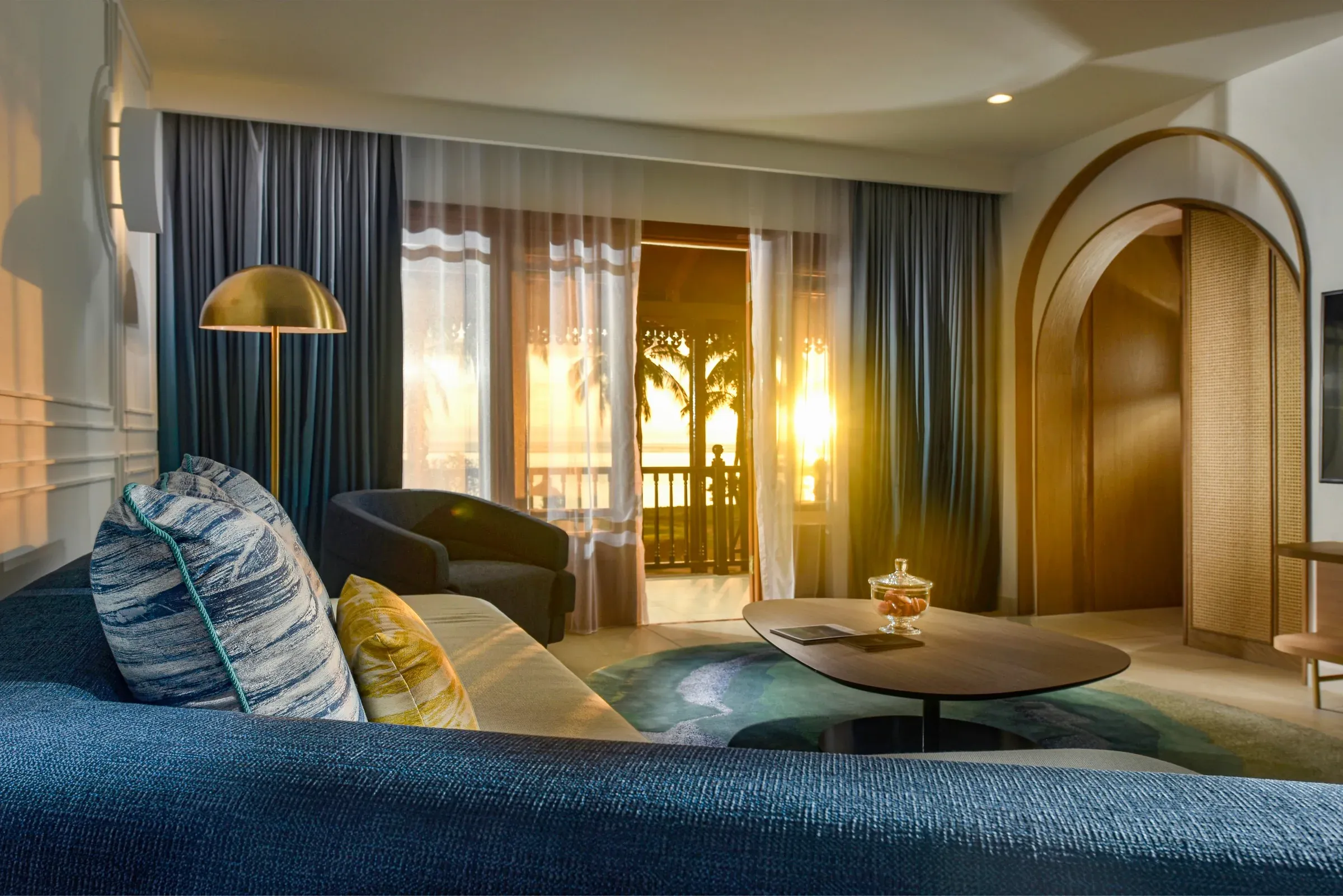 Opera Suite living room at sunset with beach terrace at Sofitel Mauritius L'Impérial Resort & Spa