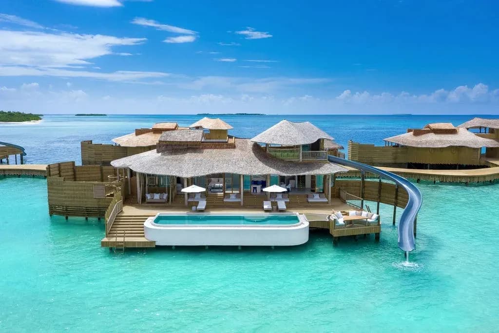 Aerial view of an overwater Water Reserve villa with private pool and deck at Soneva Jani, Noonu Atoll