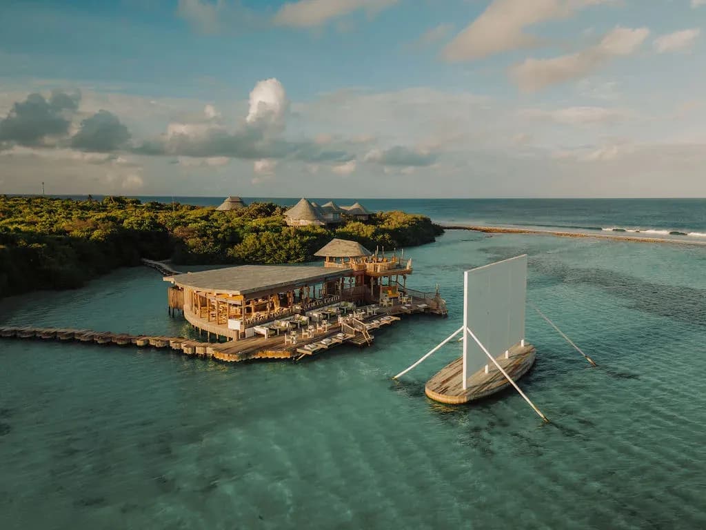 Overwater dining deck at Director's Cut, Soneva Jani, framed by open skies