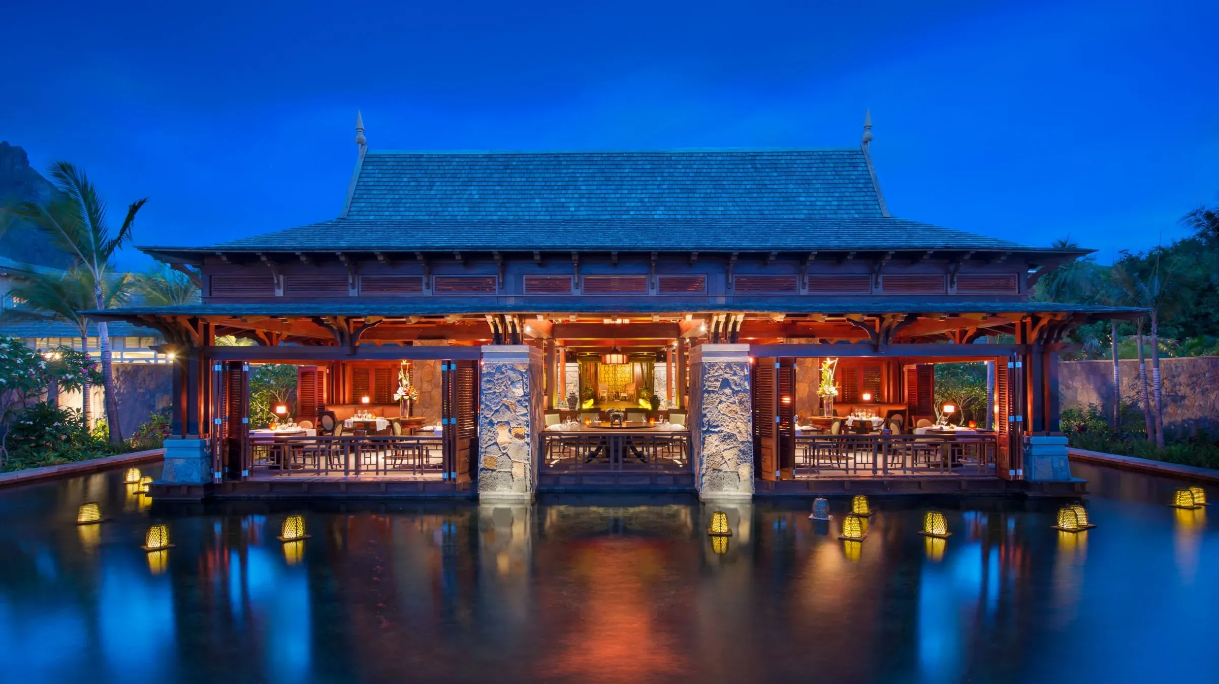 Over-water dining setting at Floating Market, the pan-Asian restaurant at The St. Regis Le Morne Resort, Mauritius