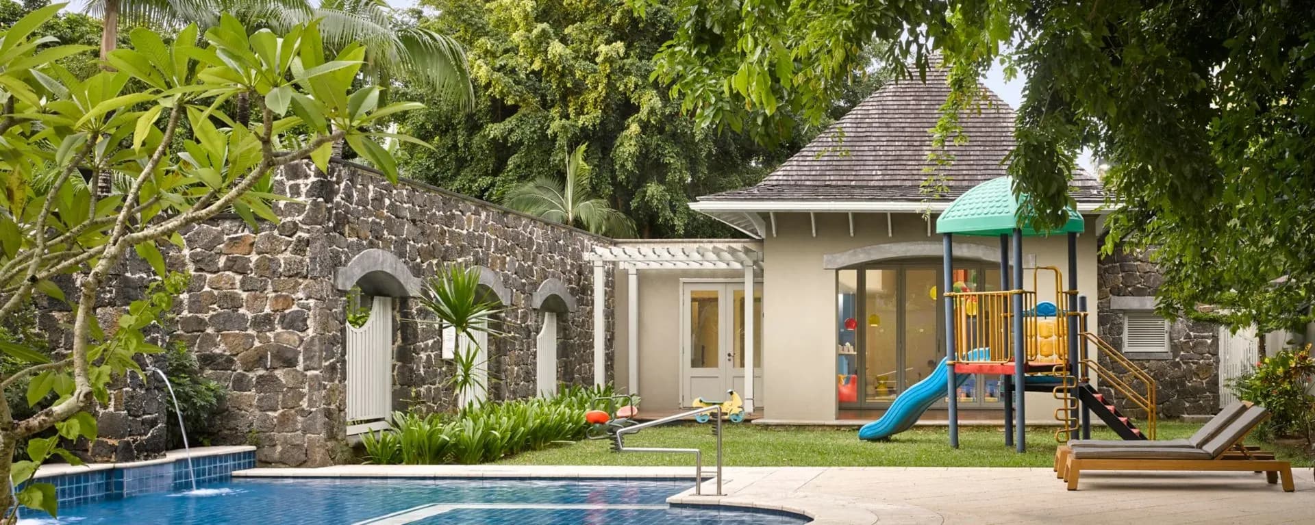 Outdoor playground and pool at The Kite Flyers Club, the resort's kids club