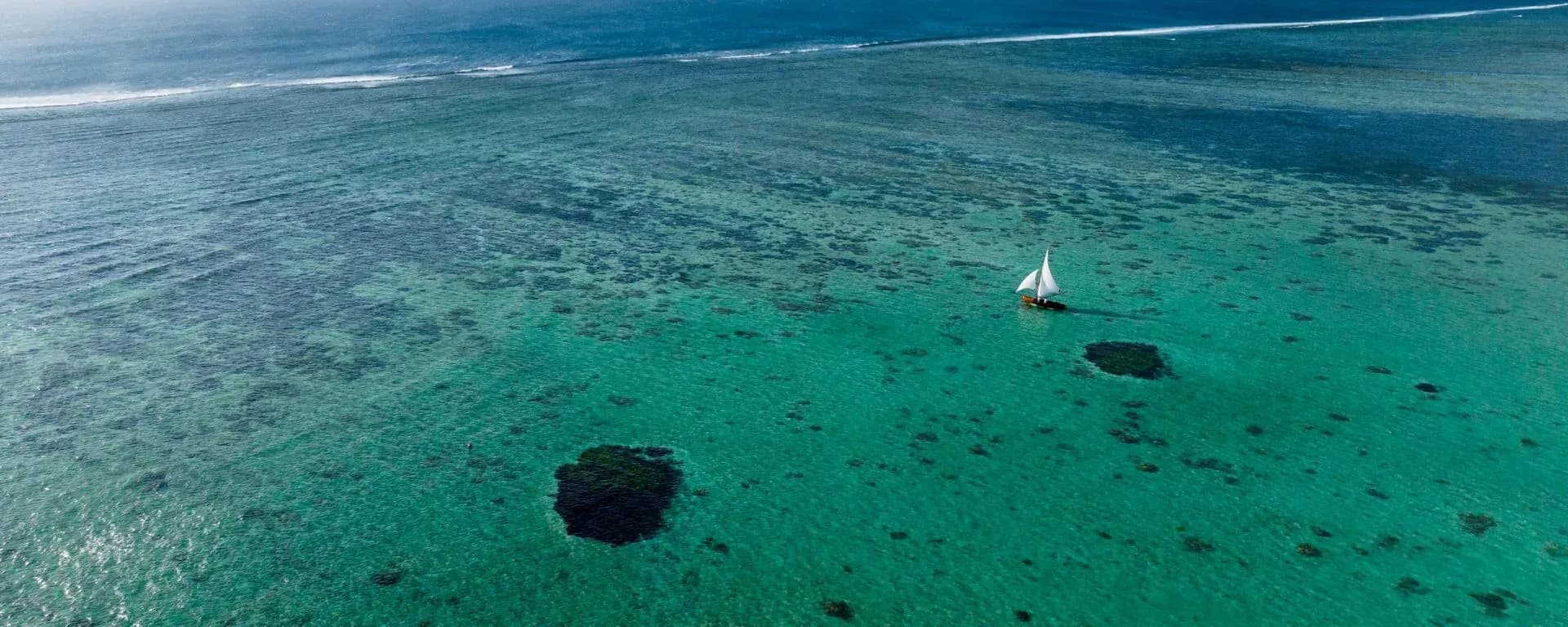 Traditional pirogue boat on the lagoon off Le Morne at The St. Regis Le Morne Resort, Mauritius