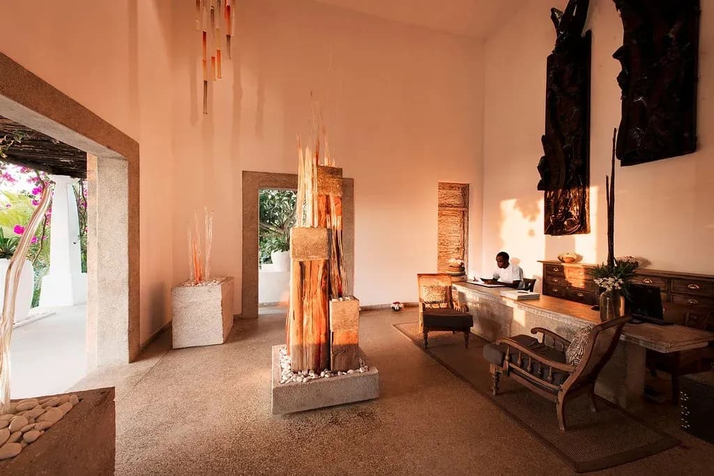 Reception pavilion with hand-carved wood sculpture at The Aiyana, Pemba Island