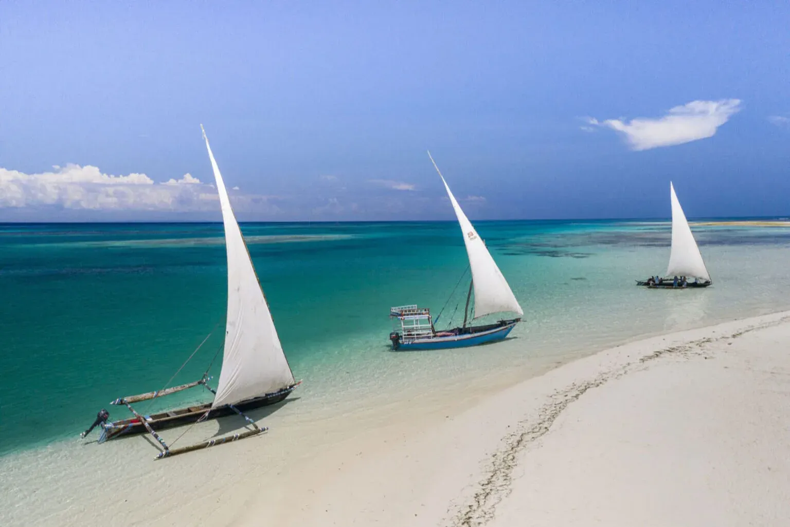 Traditional dhows anchored off the beach at The Aiyana, Pemba Island