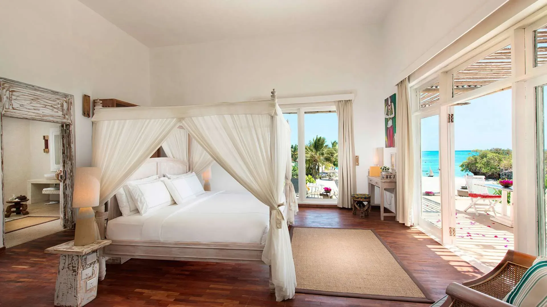 Presidential Villa four-poster bed with ocean-view terrace at The Aiyana, Pemba Island