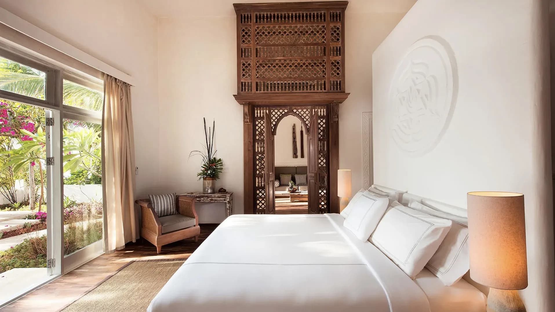 Superior Villa bedroom with carved Zanzibari doors at The Aiyana, Pemba Island
