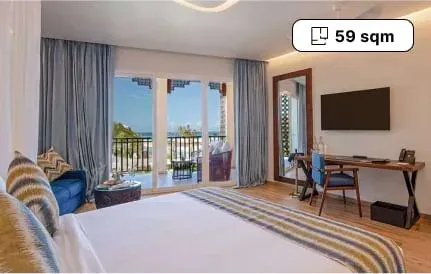 Superior Junior Suite King Ocean View bedroom with balcony over the sea at The Mora Zanzibar